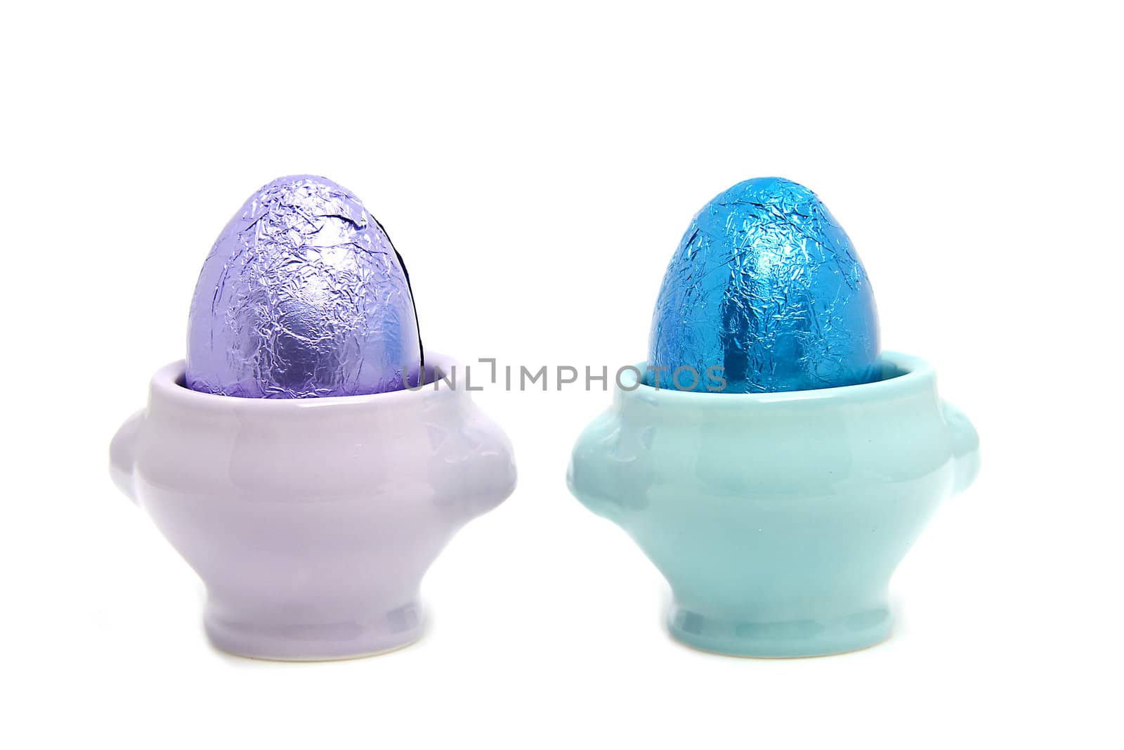 colorful easter eggs in cups isolated on white background