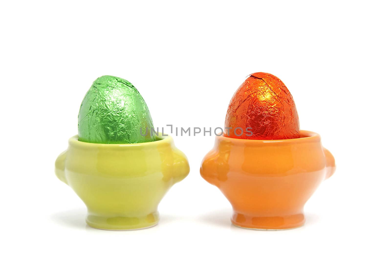 colorful easter eggs in cups isolated on white background