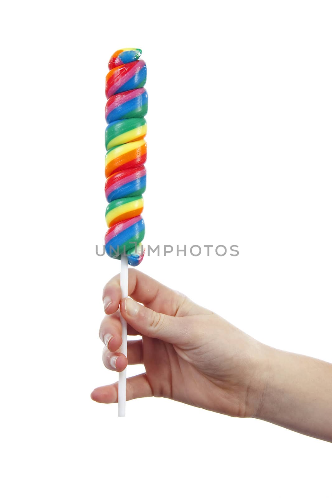 Hand is holding colorful big lollipop over white background