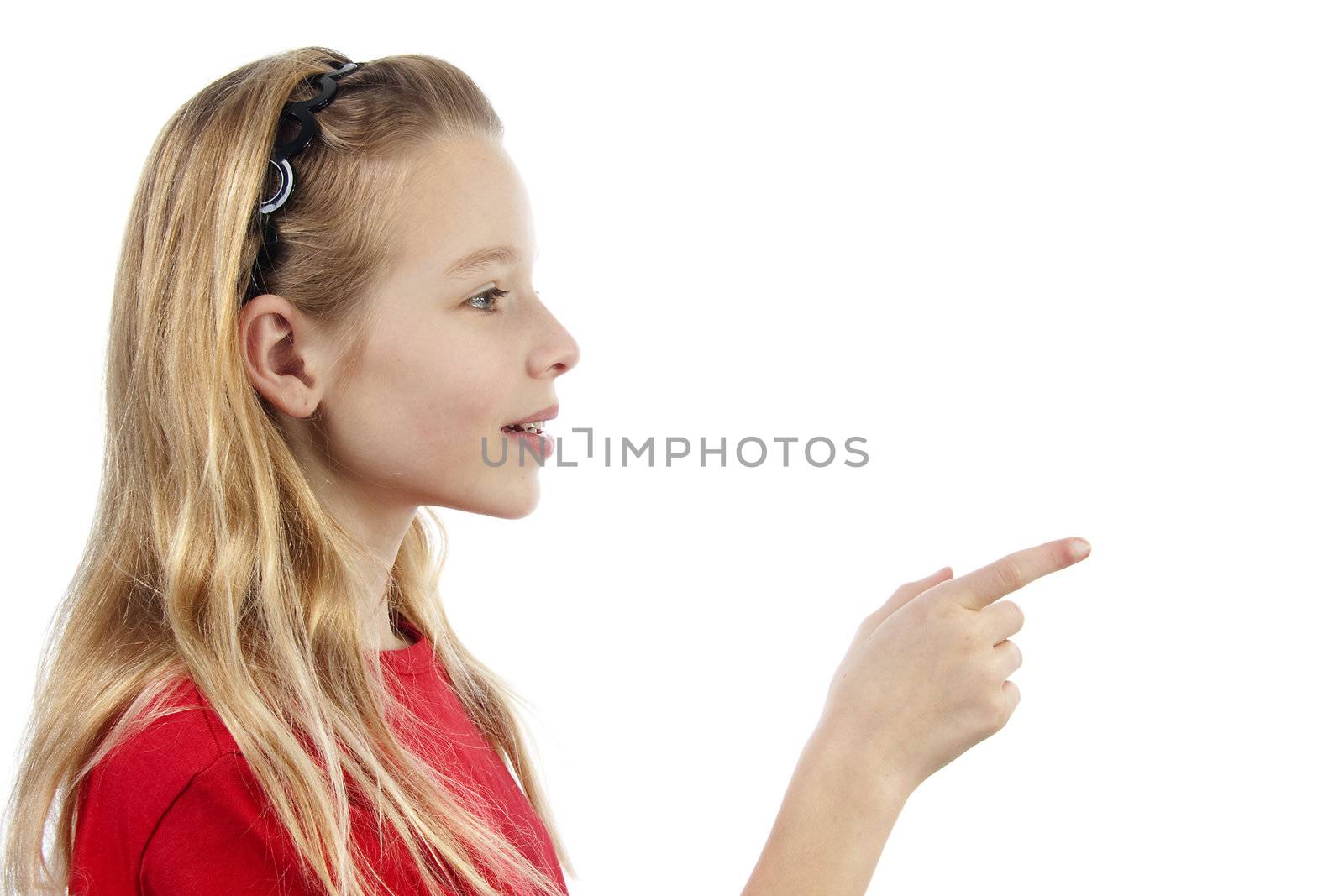 Young blonde girl points to  something over white background