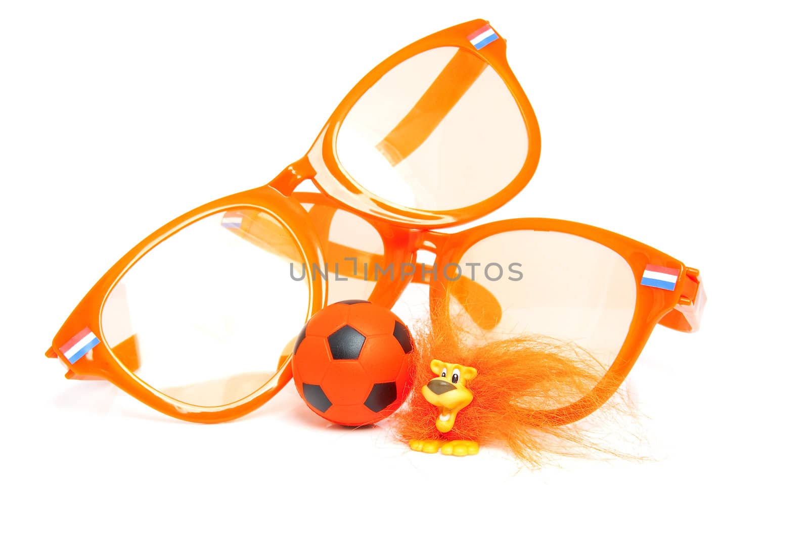 Orange soccer accessory: big glasses, ball and Dutch lion over white background