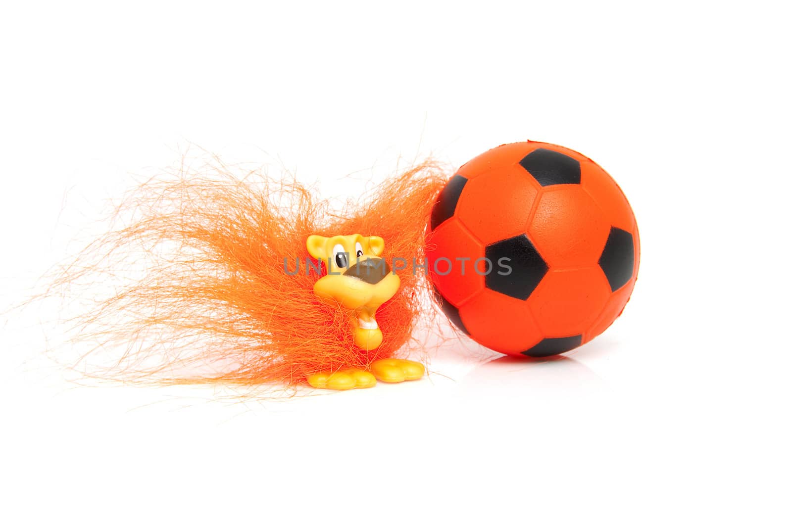 Orange soccer accessory: ball and Dutch lion over white background