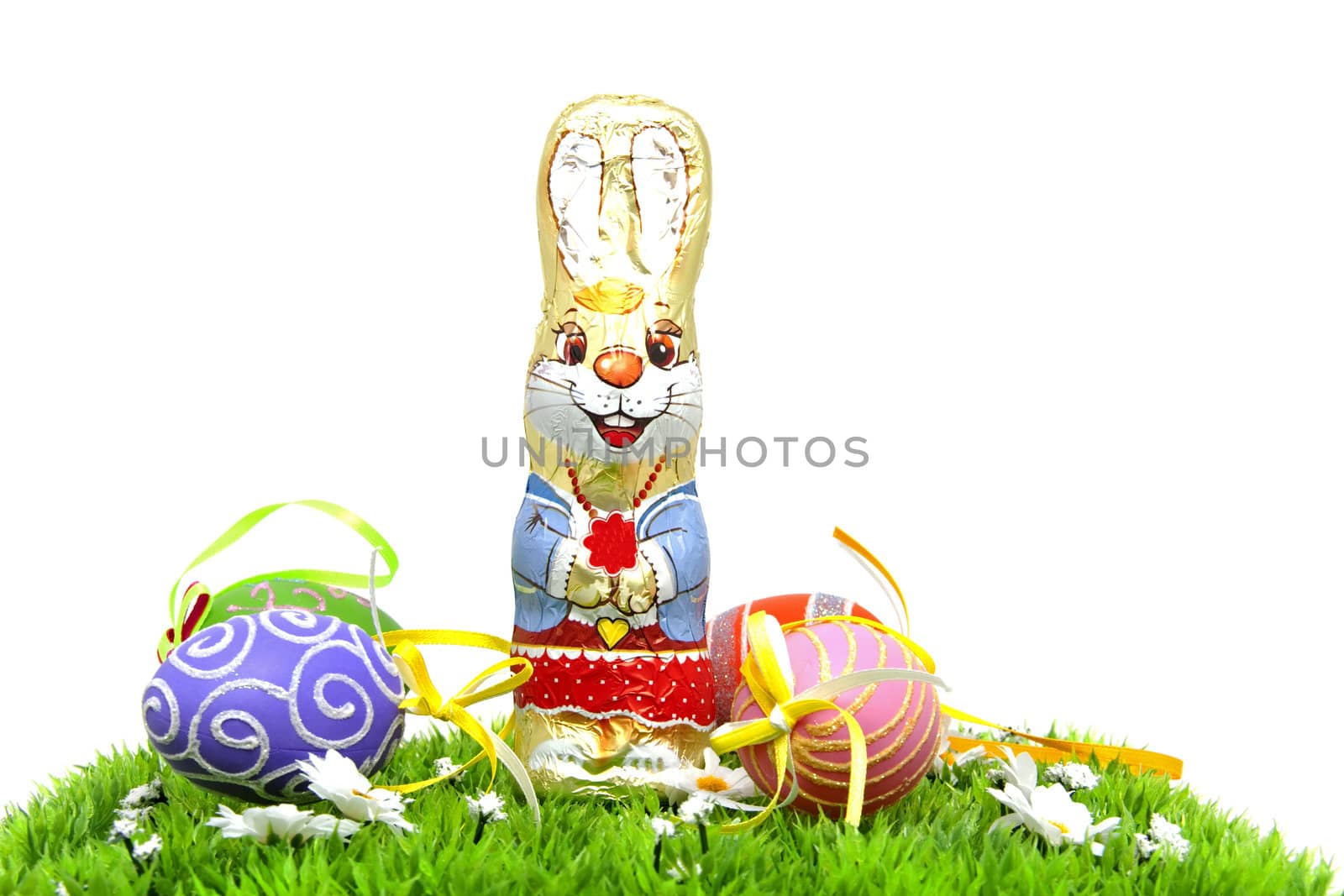 Chocolate easter bunny and colorful eggs on grass over white background