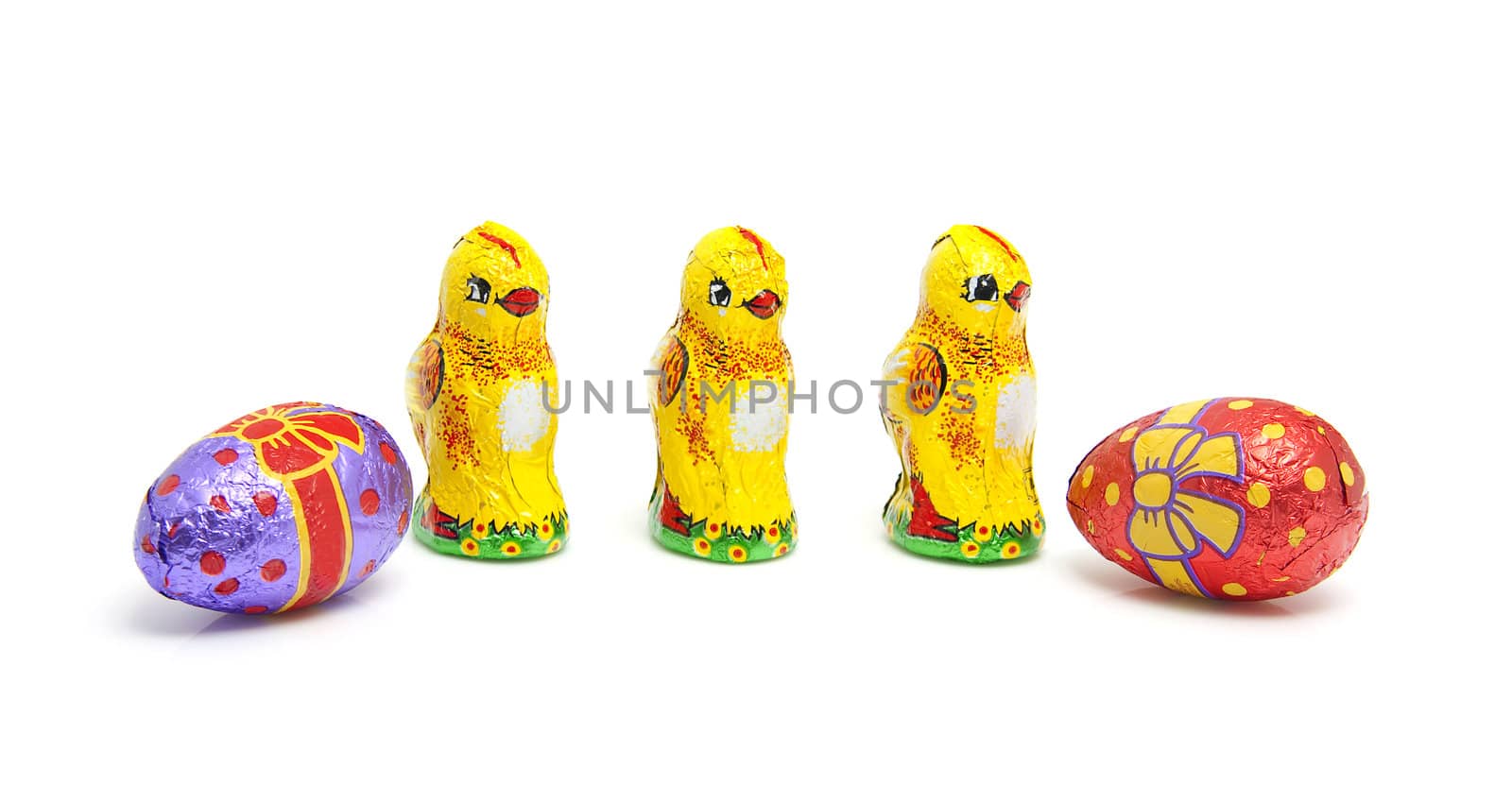 Chocolate easter eggs and chickens over white background