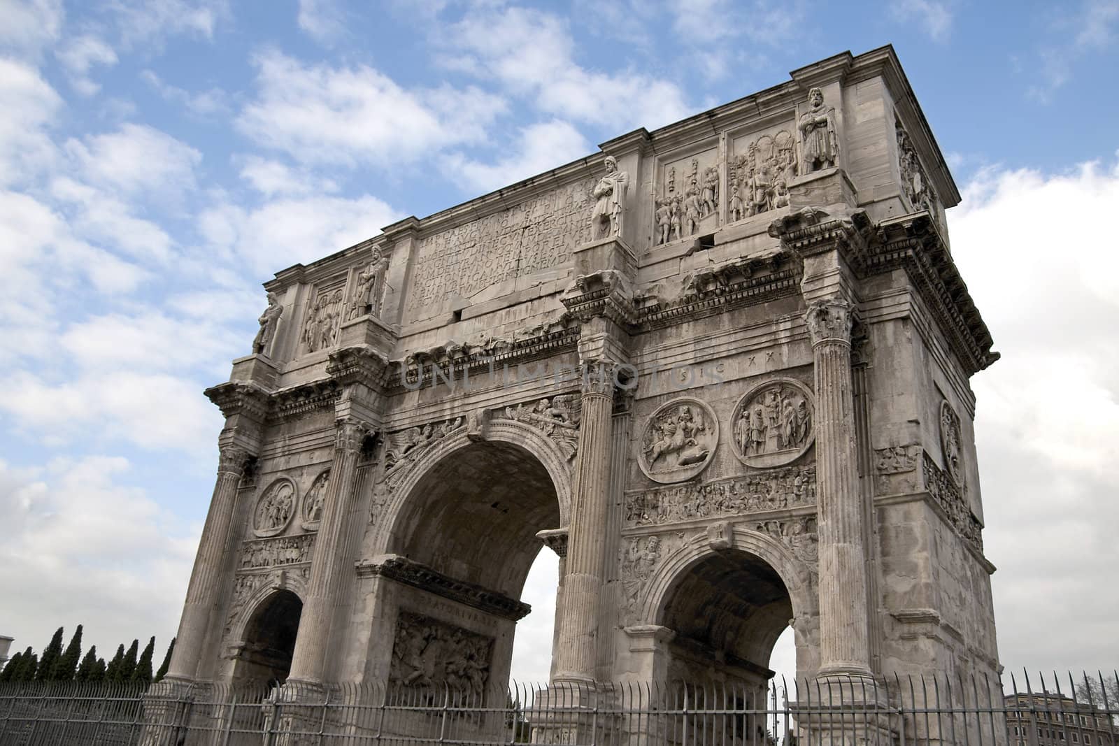 View of Arco Di Costantino (Arch of Constantine) in Rome, Italy. It was erected to commemorate Constantine I's victory over Maxentius at the Battle of Milvian Bridge on October 28, 312.The arch is 21 m high, 25.7 m wide and 7.4 m deep.