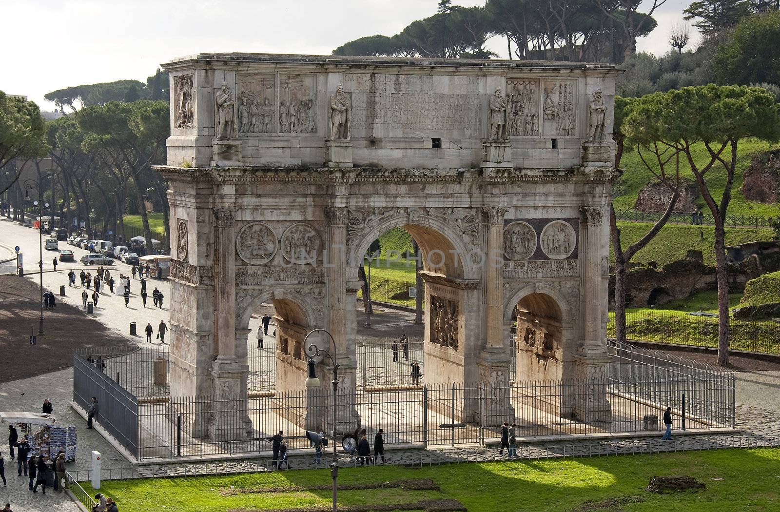Arco Di Costantino (Arch of Constantine) in Rome seen from the Colosseum, Italy. It was erected to commemorate Constantine I's victory over Maxentius at the Battle of Milvian Bridge on October 28, 312.The arch is 21 m high, 25.7 m wide and 7.4 m deep.