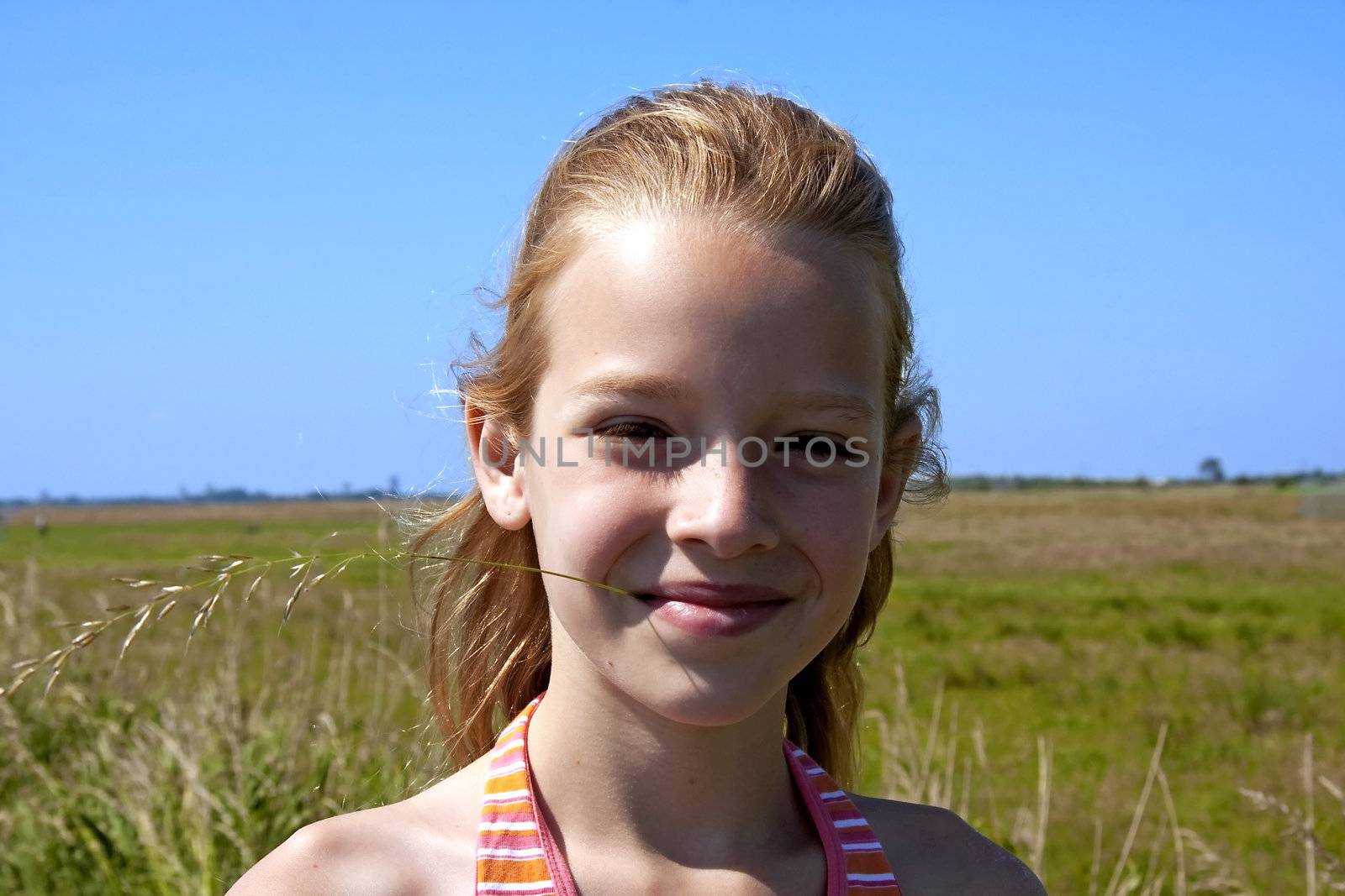 portrait of a young girl looking in camera on sunny day