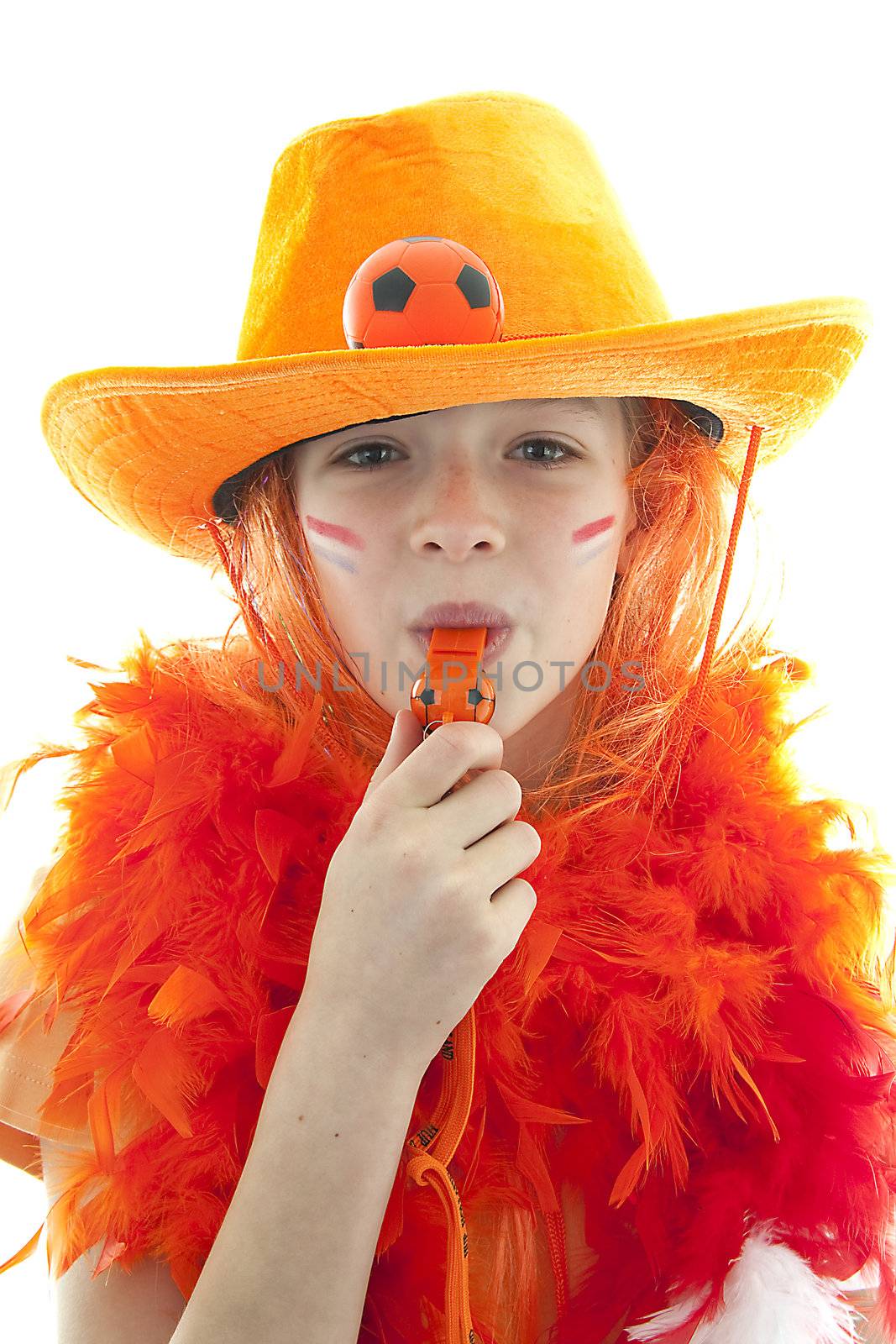 Happy soccer supporter: young blonde girl in orange outfit blow on flute