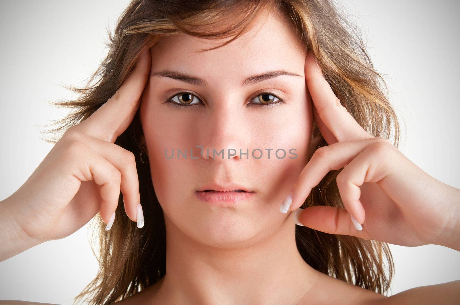 Woman suffering from an headache, holding her hands to the head