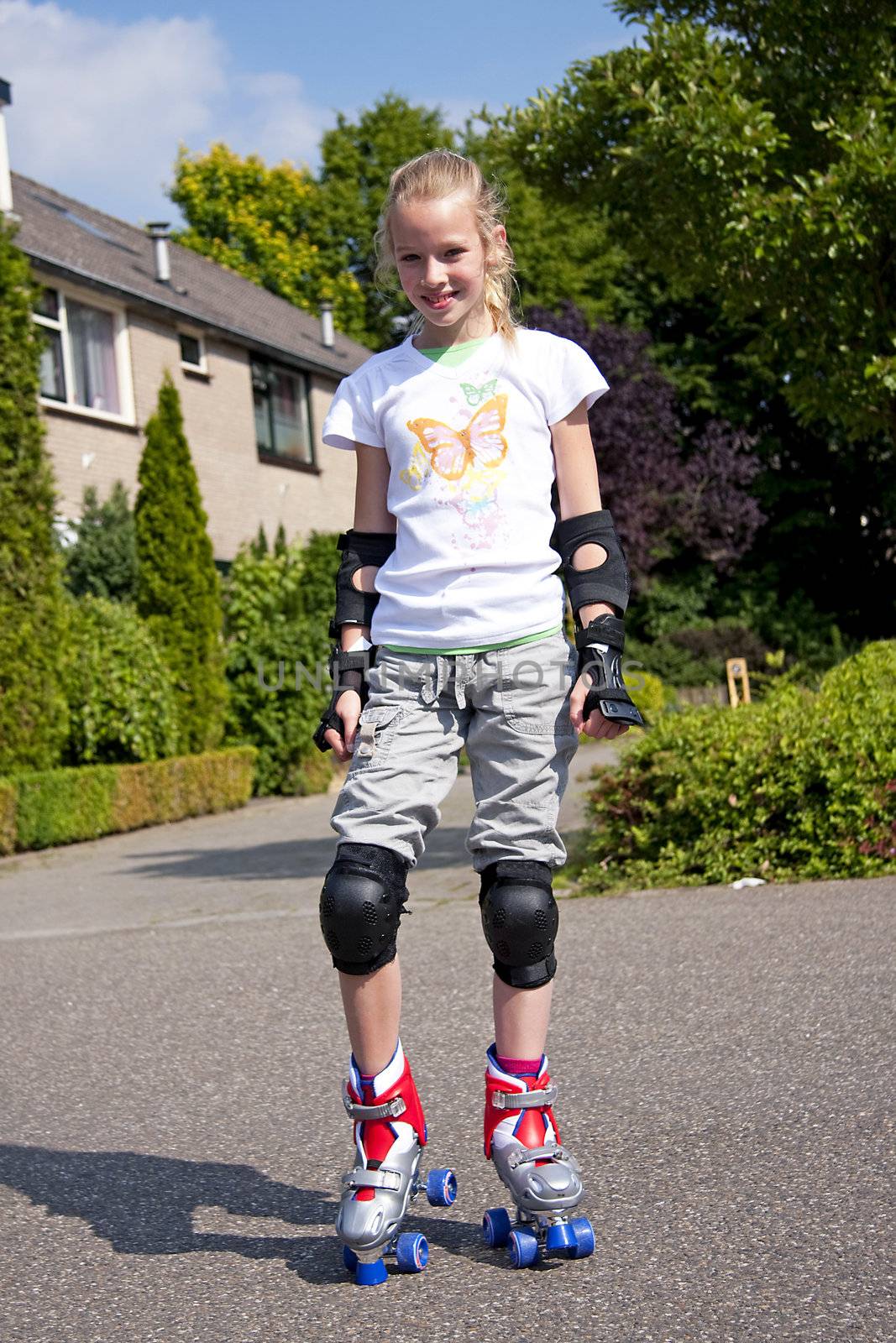 Young blonde girl on roller skate heaving fun