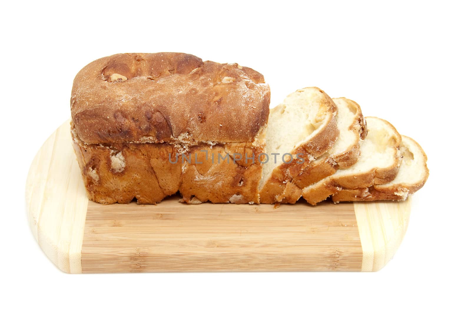baked sugar bread in closeup on wooden cutting board over white background