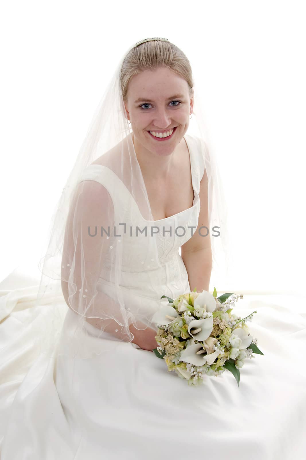 Young beautiful bride with bouquet is smiling over white background