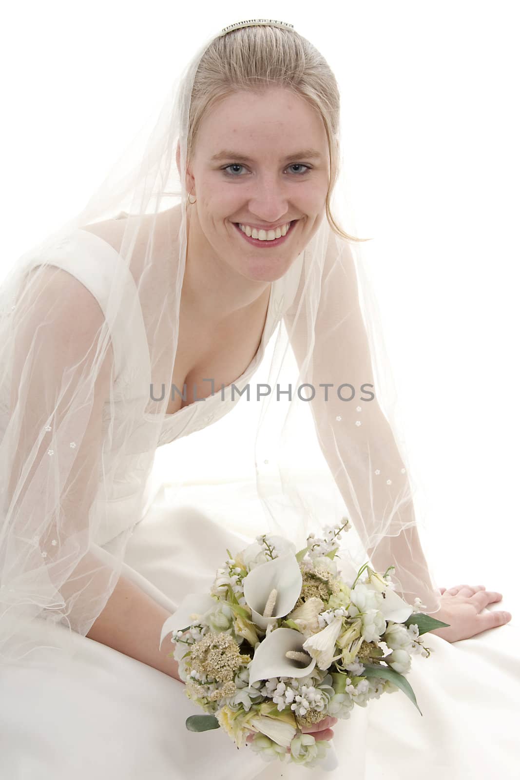 Young beautiful bride with bouquet is smiling over white background