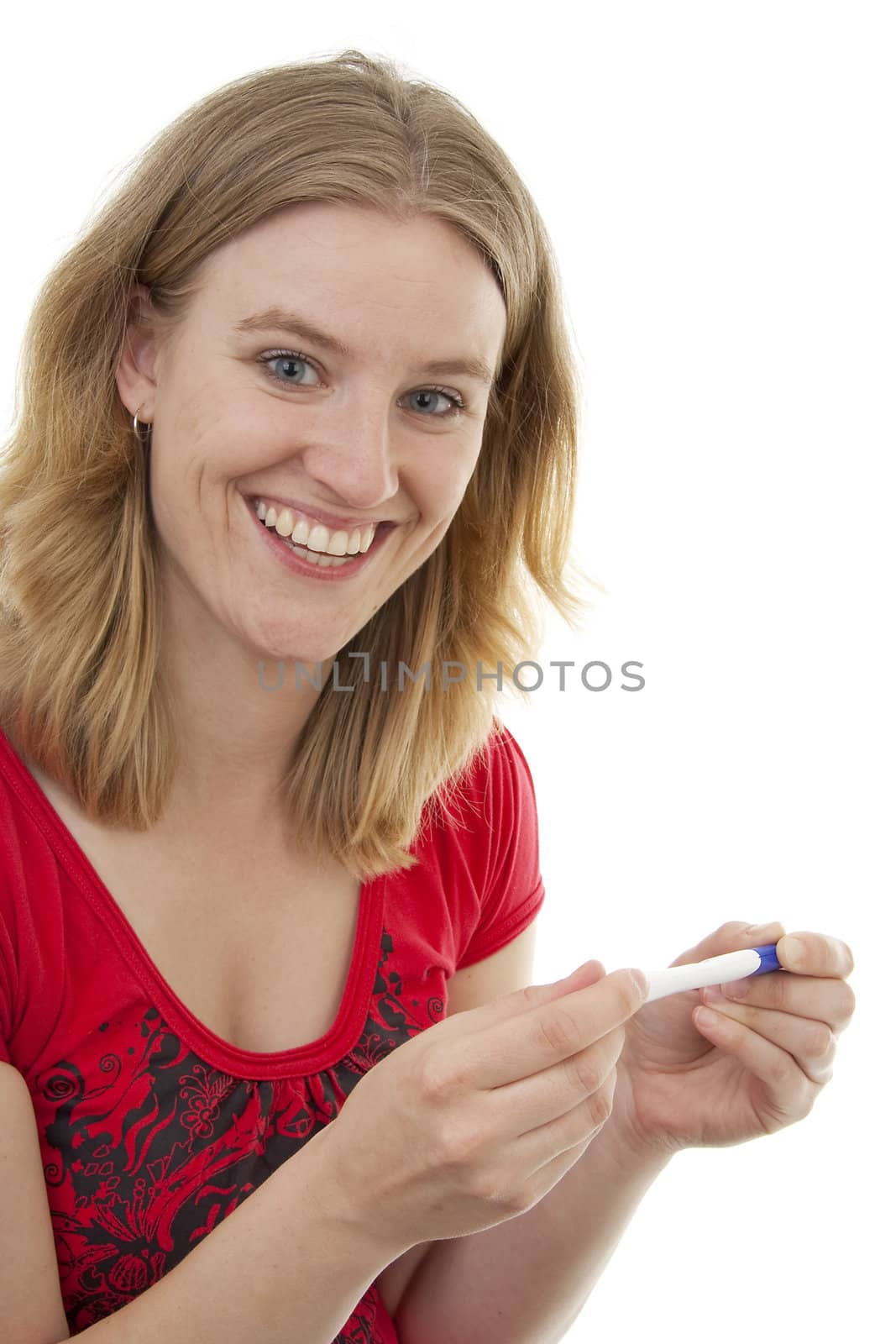 Woman with pregnancy tast is smiling because she is pregnant, over white background