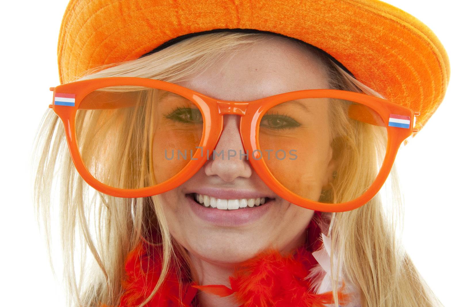 portrait of Dutch soccer fan in orange outfit with big glasses and hat over white background