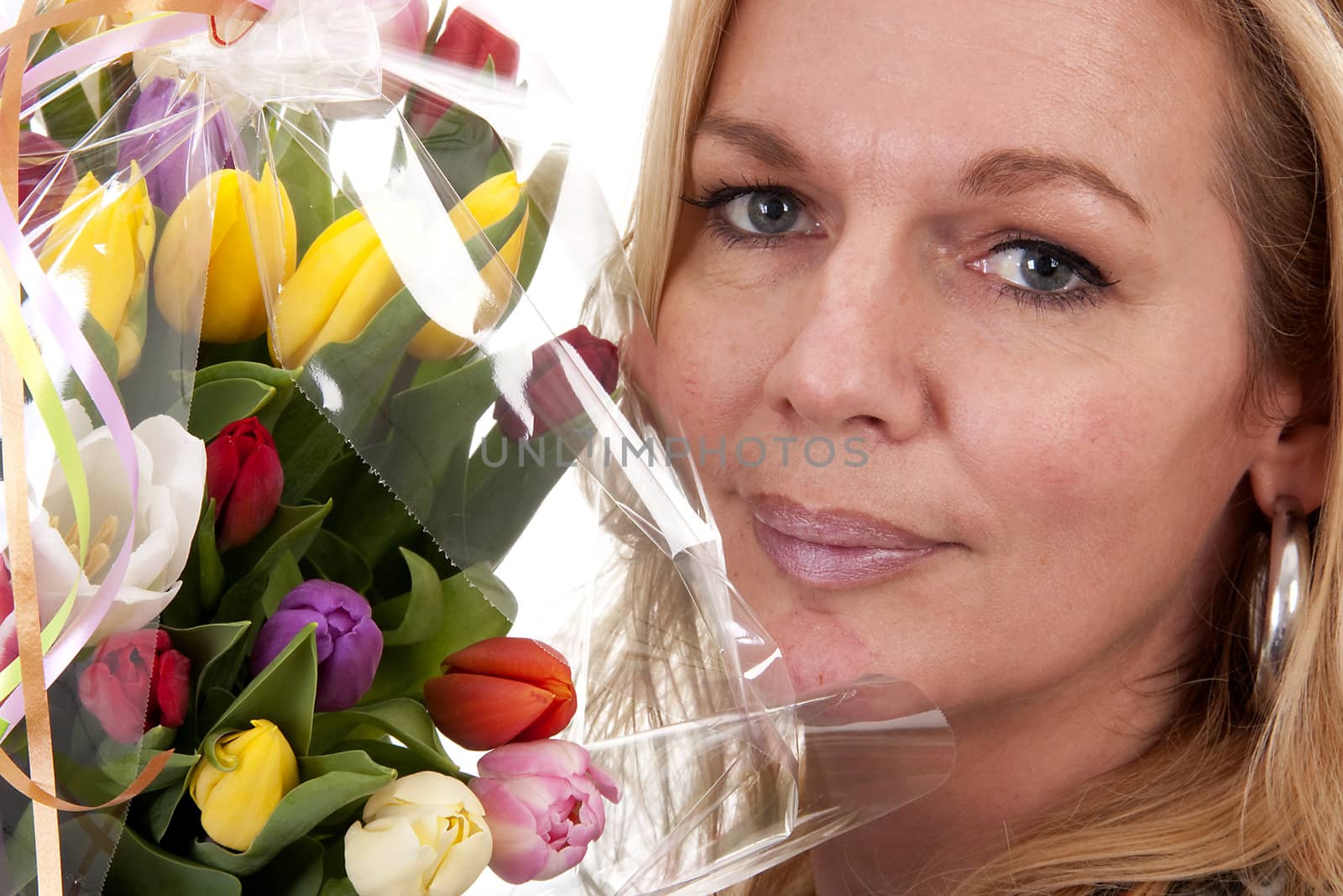 Woman with Dutch tulip flowers in closeup over white background