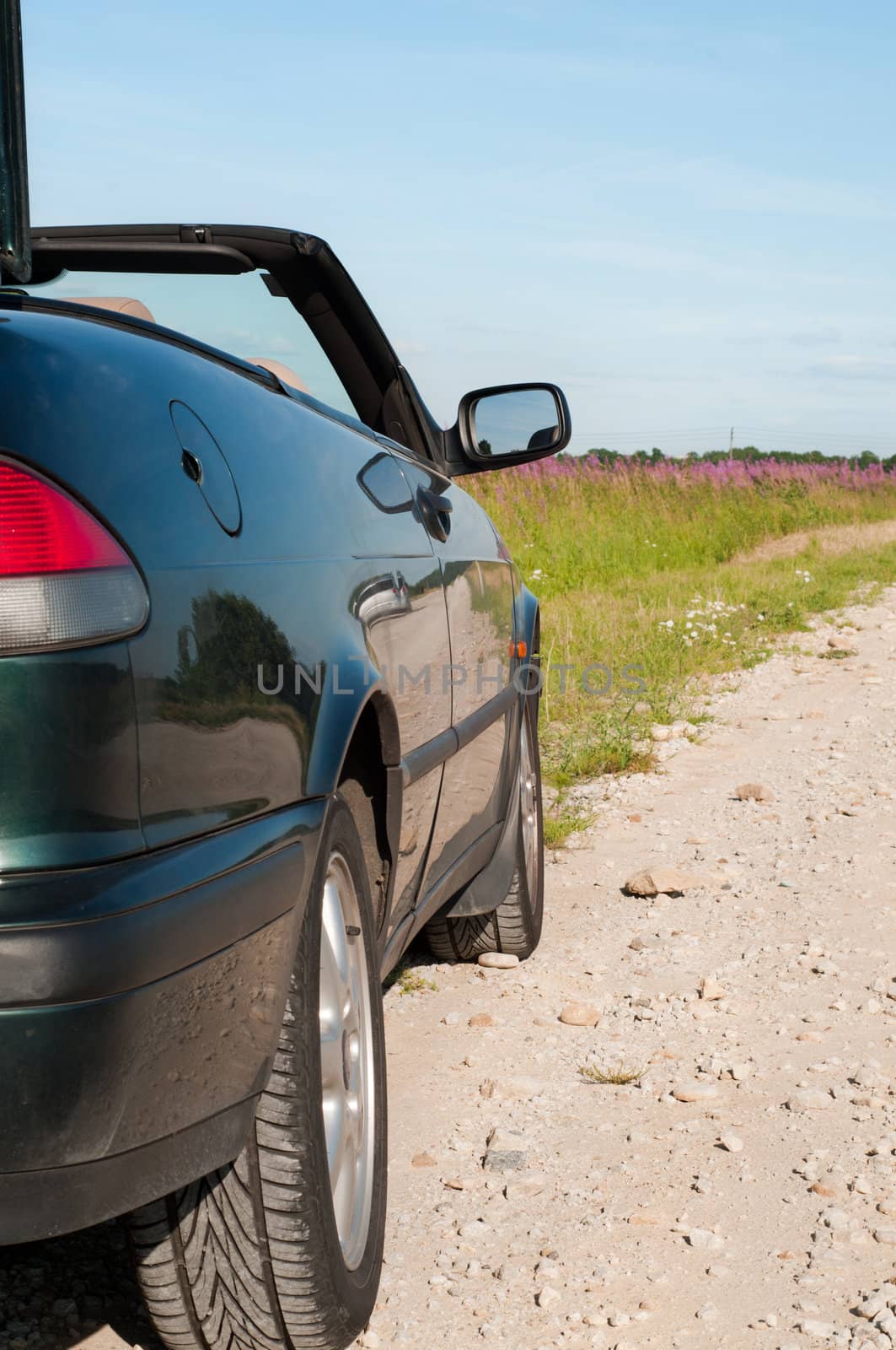 Shot of dark green cabrio on the road