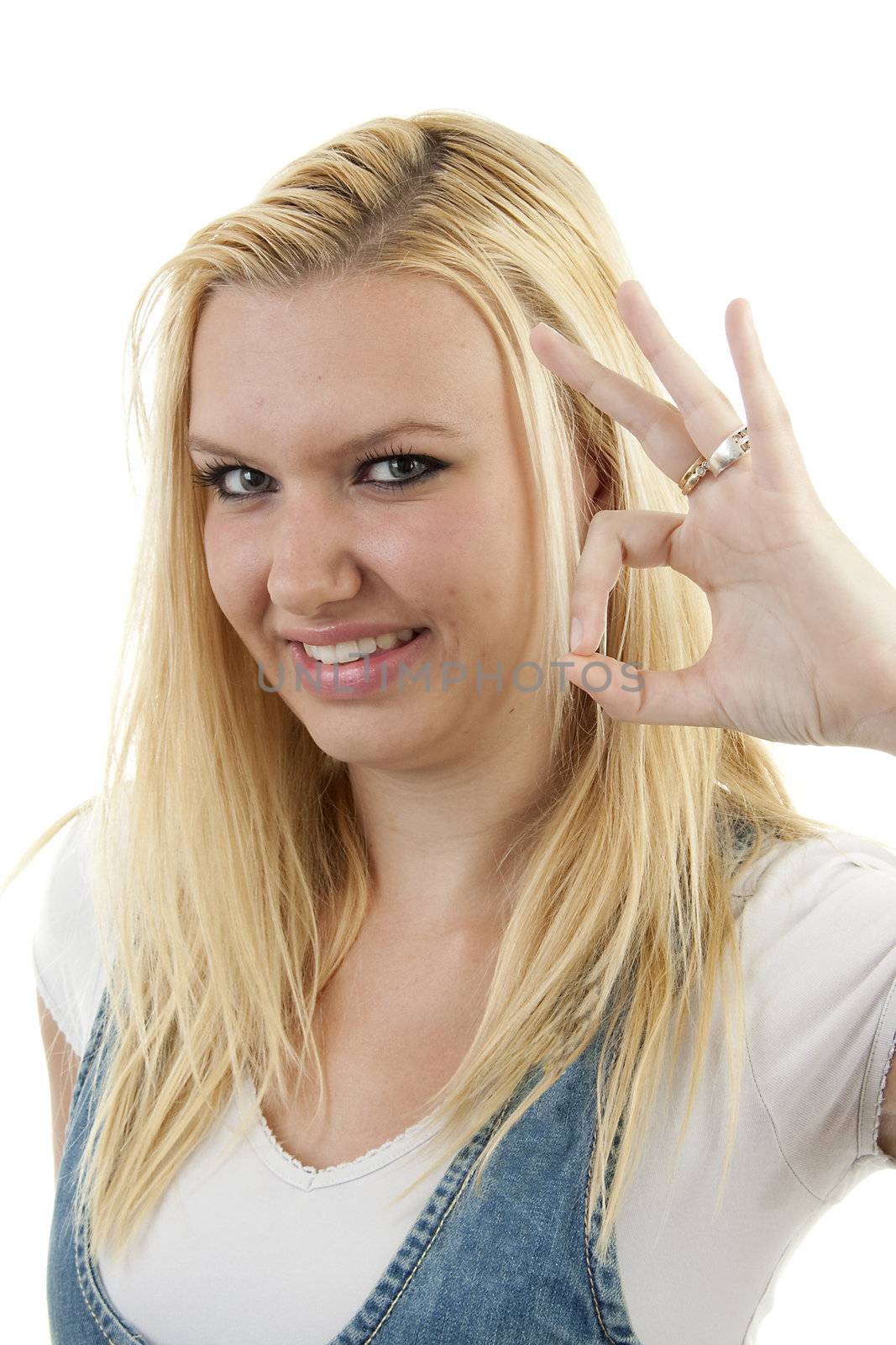 Young blonde woman is making OK sign with fingers over white background