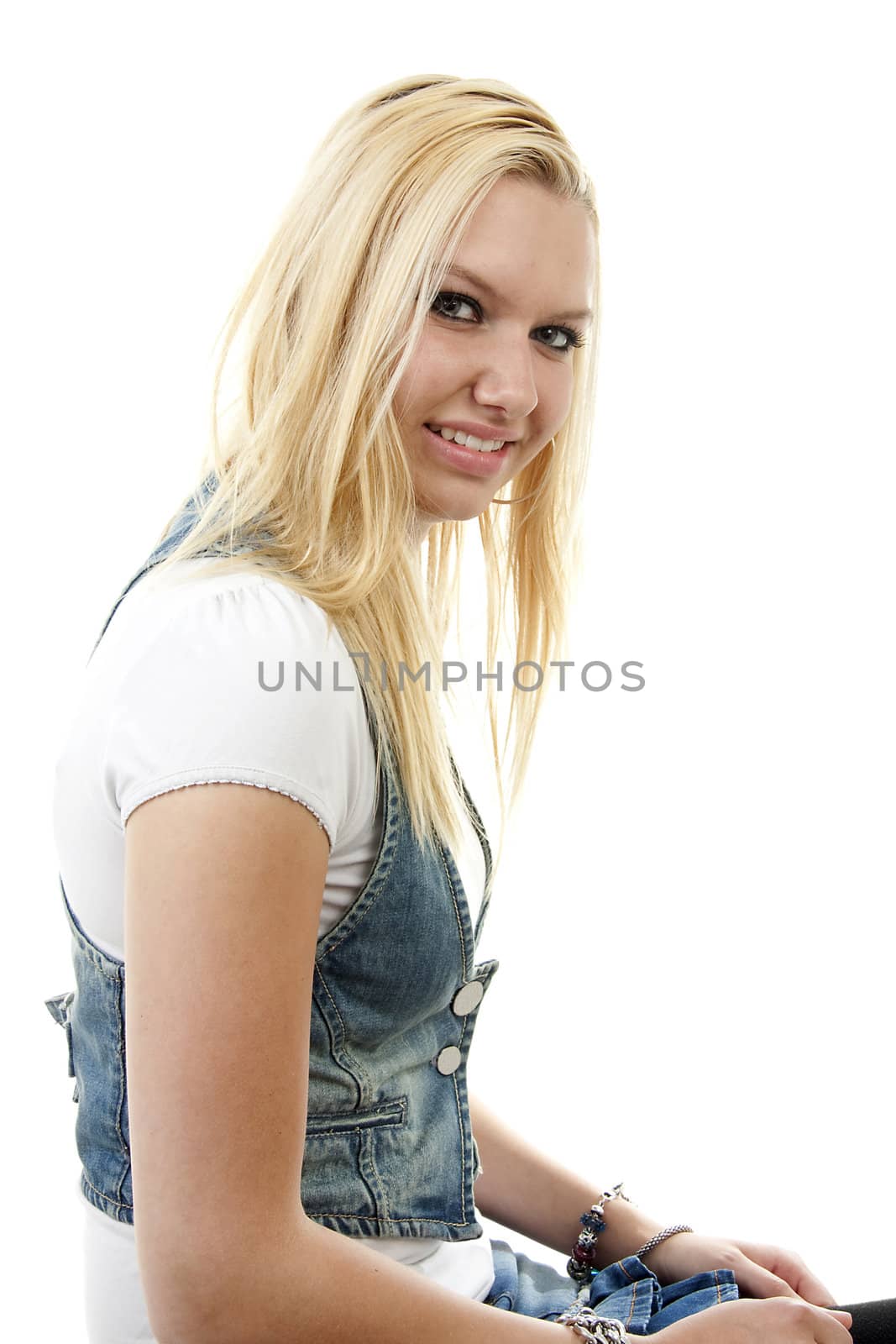 Young blonde woman is posing over white background