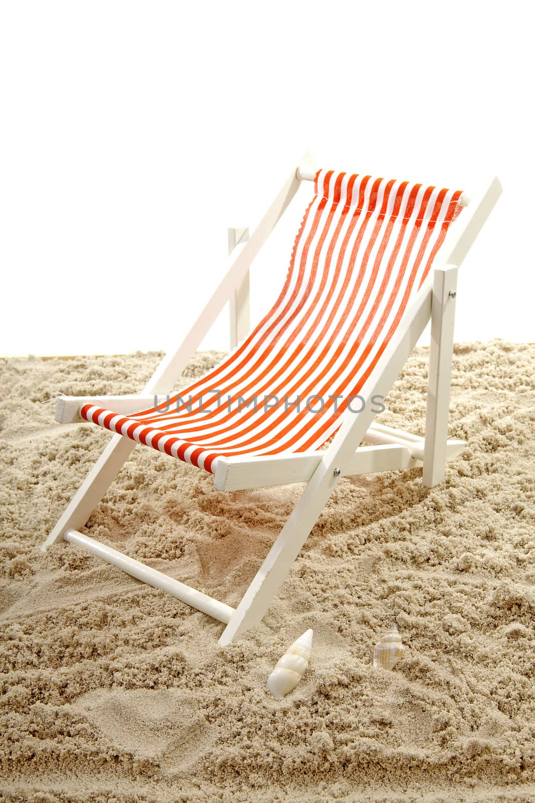 Beach chair on sand over white background