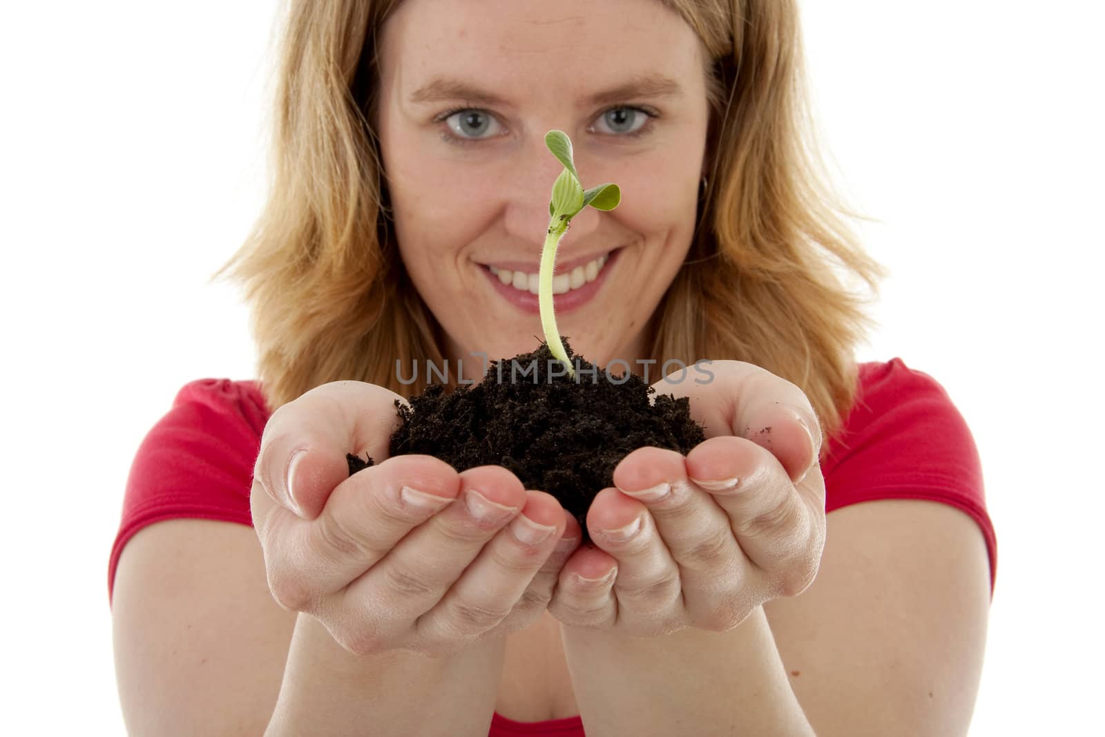 Woman is holding Pile of black garden soil with young plant for new life over white background