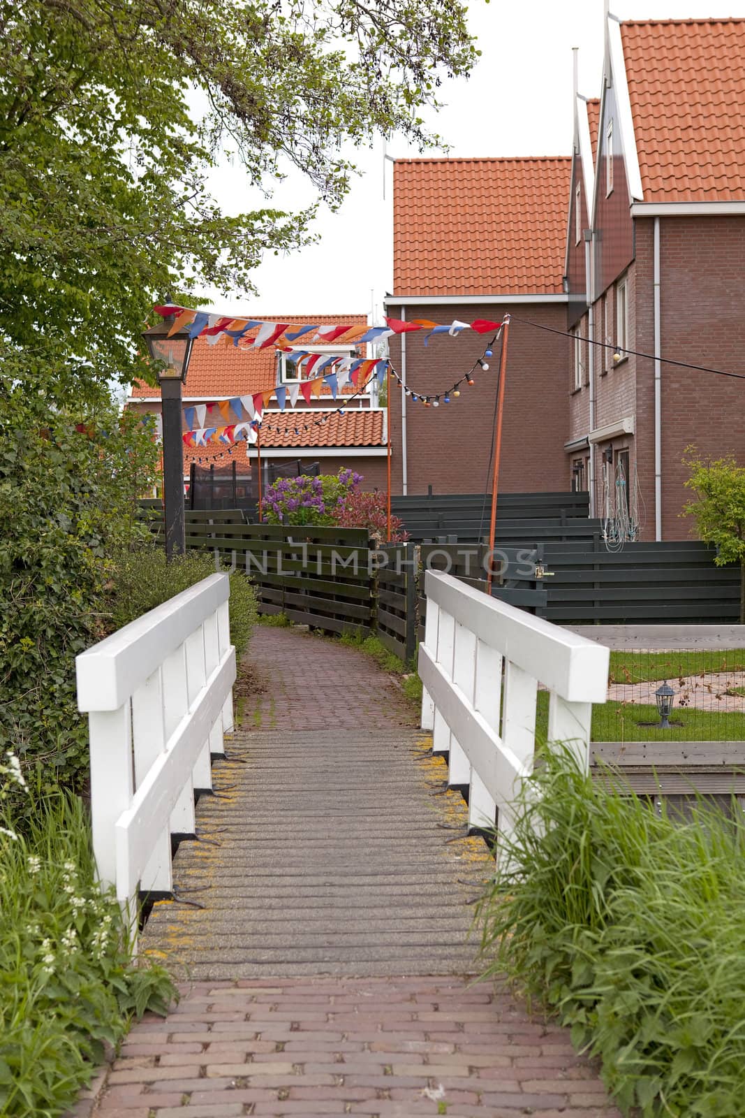 Typical Dutch street with little flags for soccer game in village Marken, Netherlands