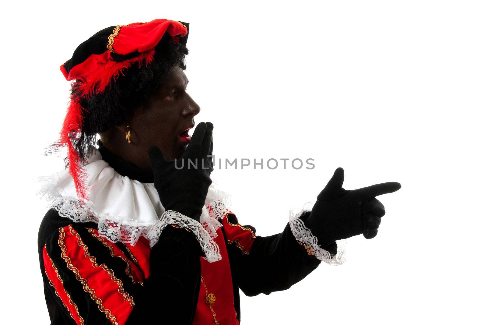 surprised Zwarte piet ( black pete) typical Dutch character part of a traditional event celebrating the birthday of  Sinterklaas in december over white background pointing