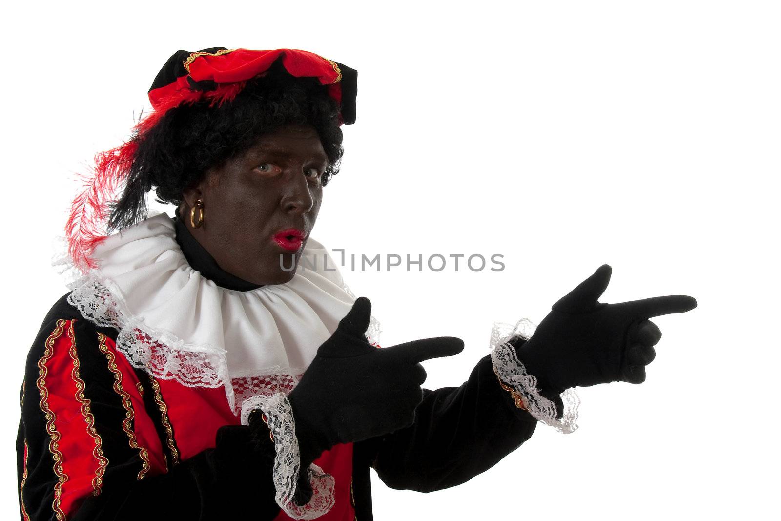 surprised Zwarte piet ( black pete) typical Dutch character part of a traditional event celebrating the birthday of  Sinterklaas in december over white background is pointing