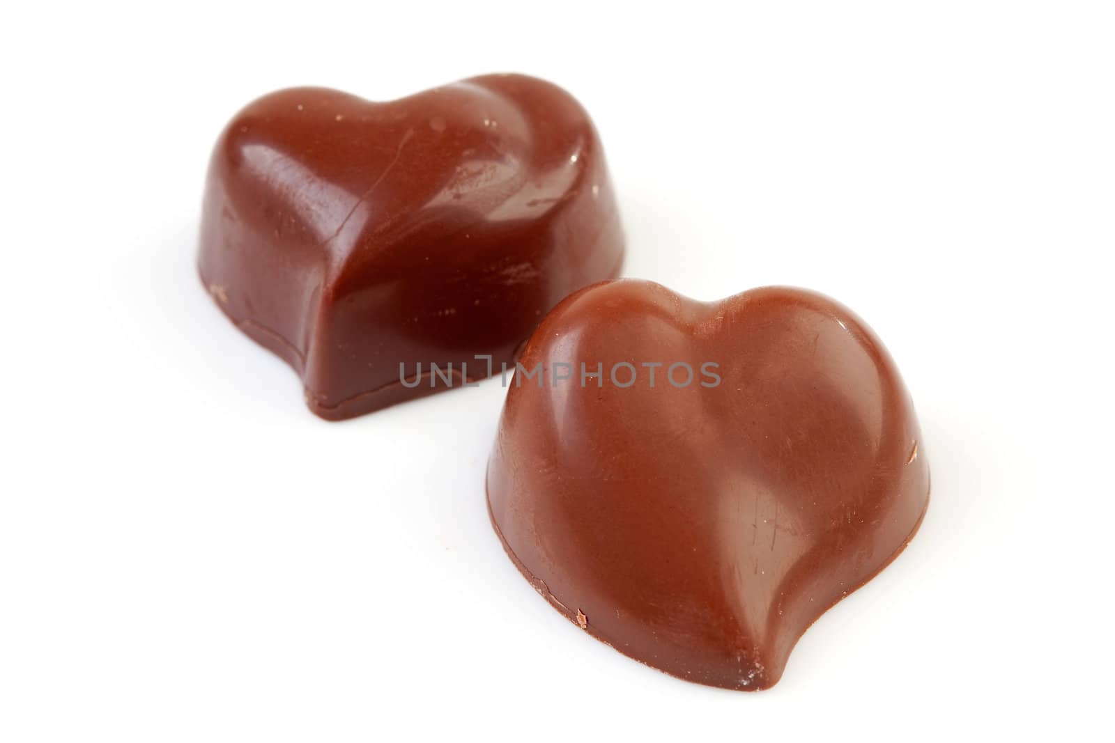 chocolates in shape of hearts isolated on white background