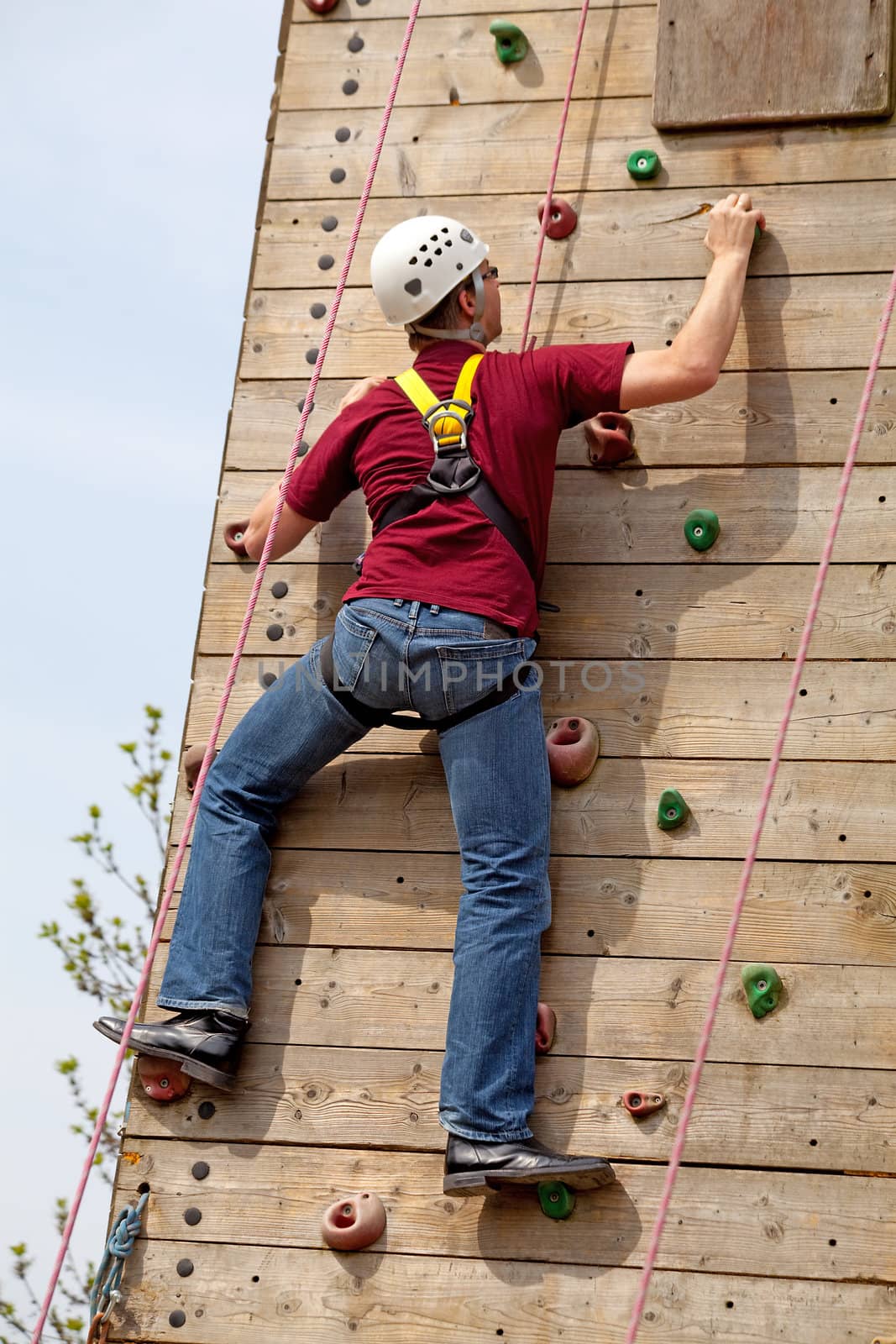 man is on climbing wall in the nature