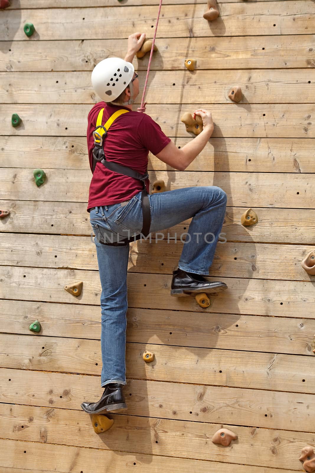 man is on climbing wall in the nature
