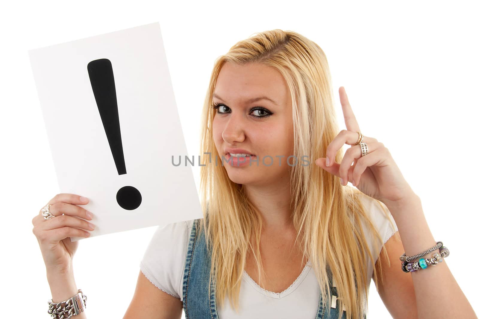 Woman is holding board with exclamation marks over white background