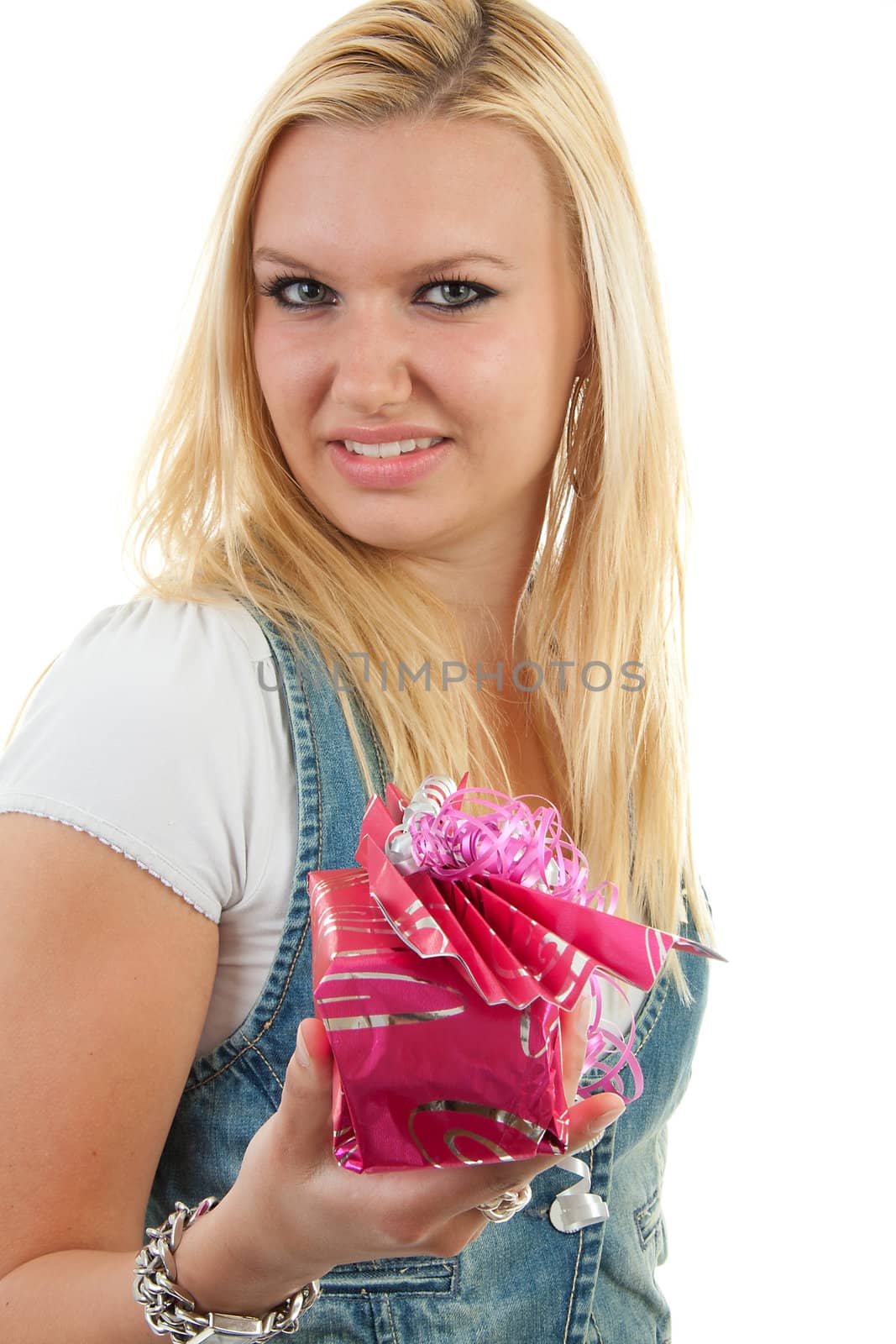 Young blonde woman is giving present over white background