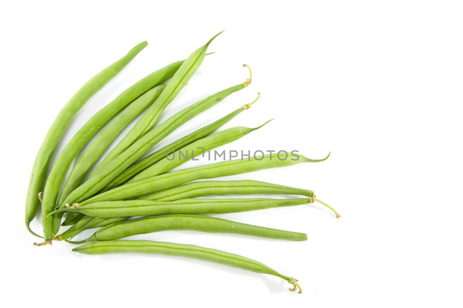 raw long green beans over white background