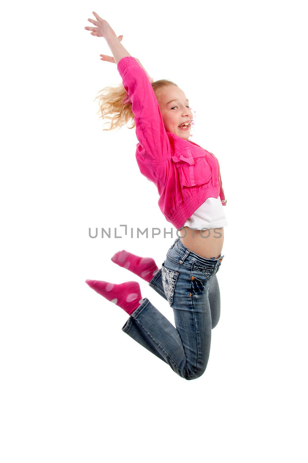 Little blonde girl is jumping in the air over white background