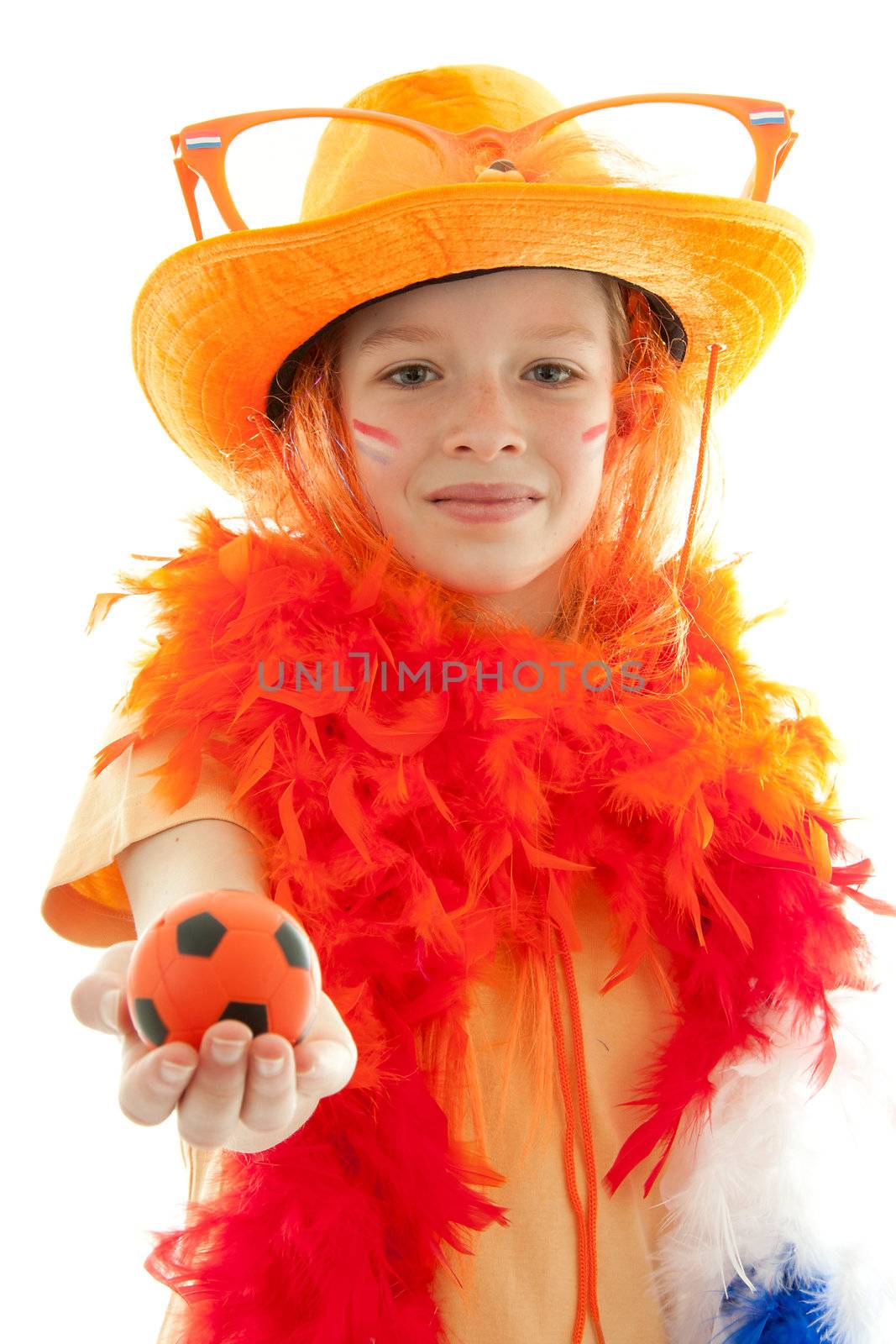 Young Dutch soccer supporter in orange outfit gives a ball over white background