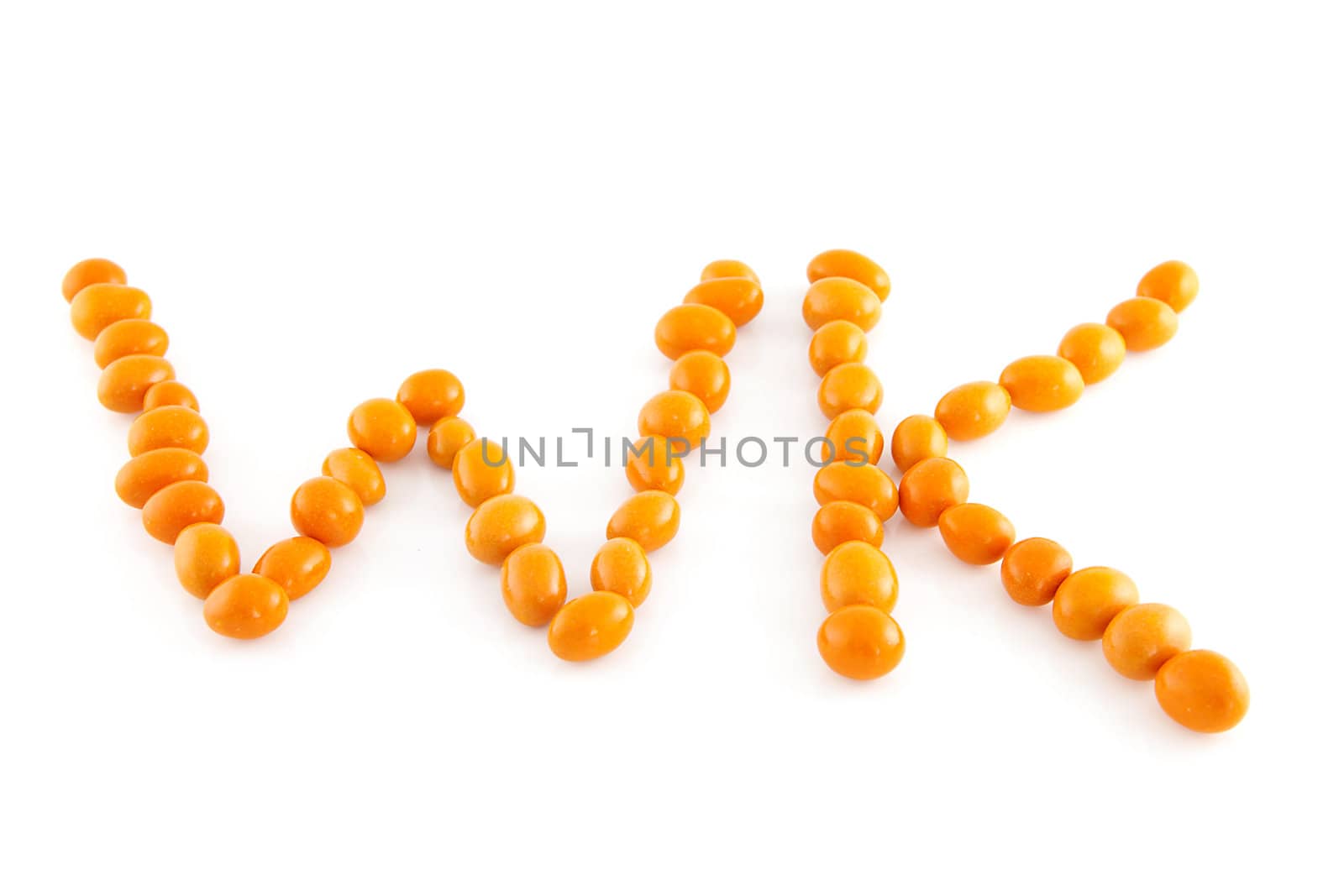 Word WK in orange peanuts isolated on white background