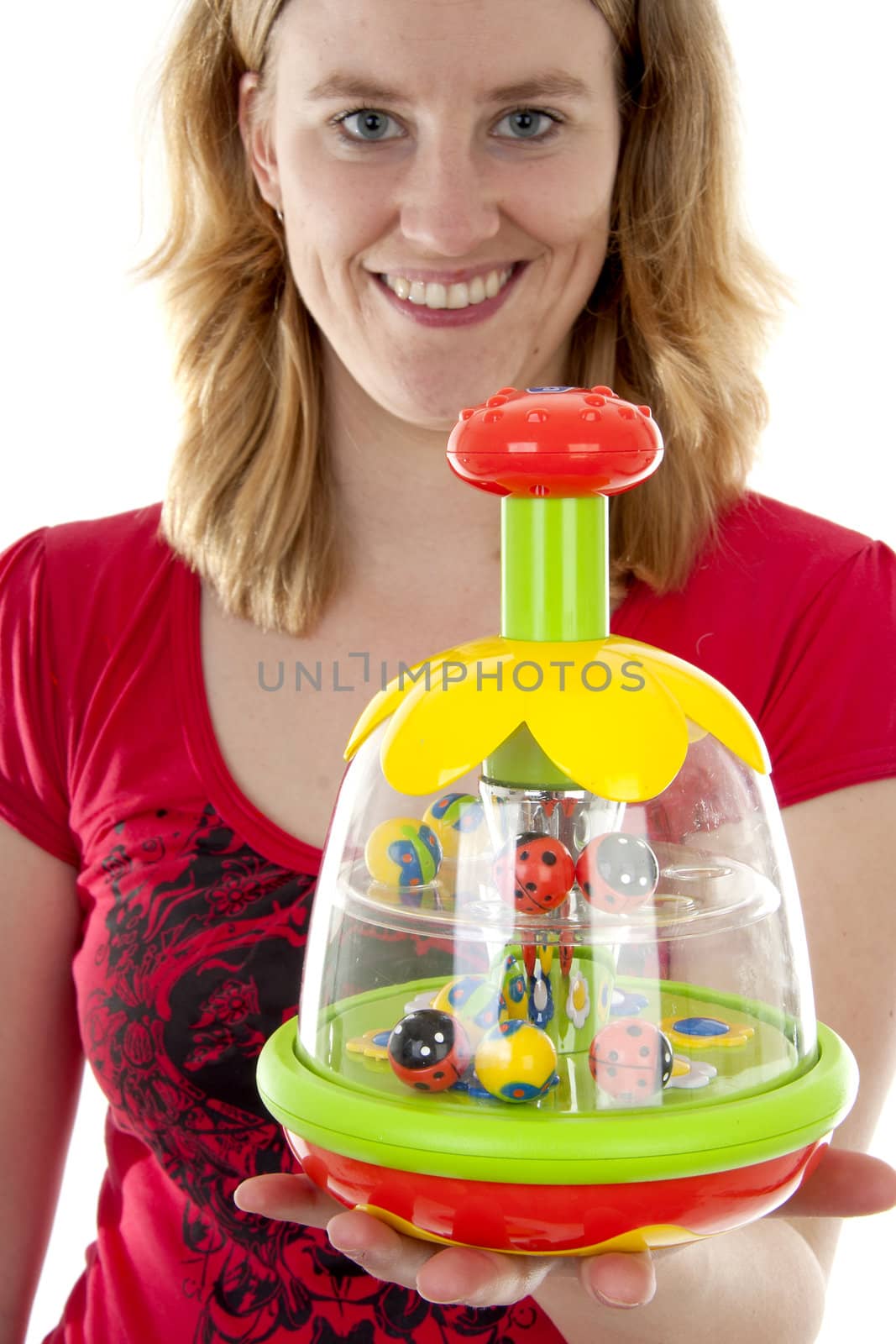 woman is holding colorful playtoy in closeup over white background