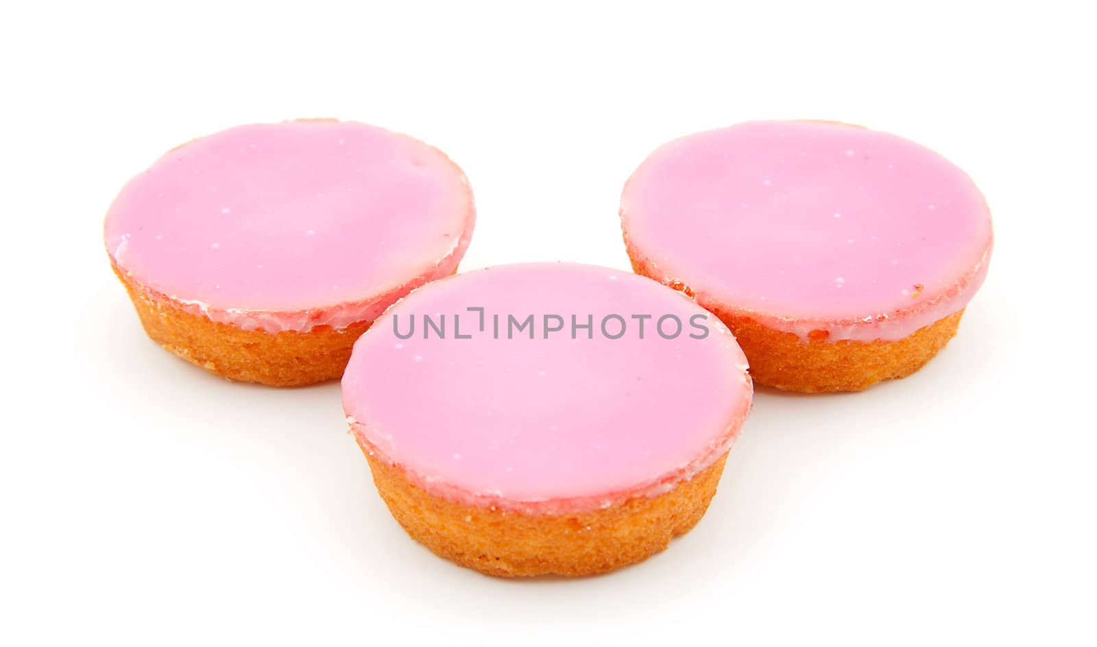 Three pink glazed cookies isolated on white background
