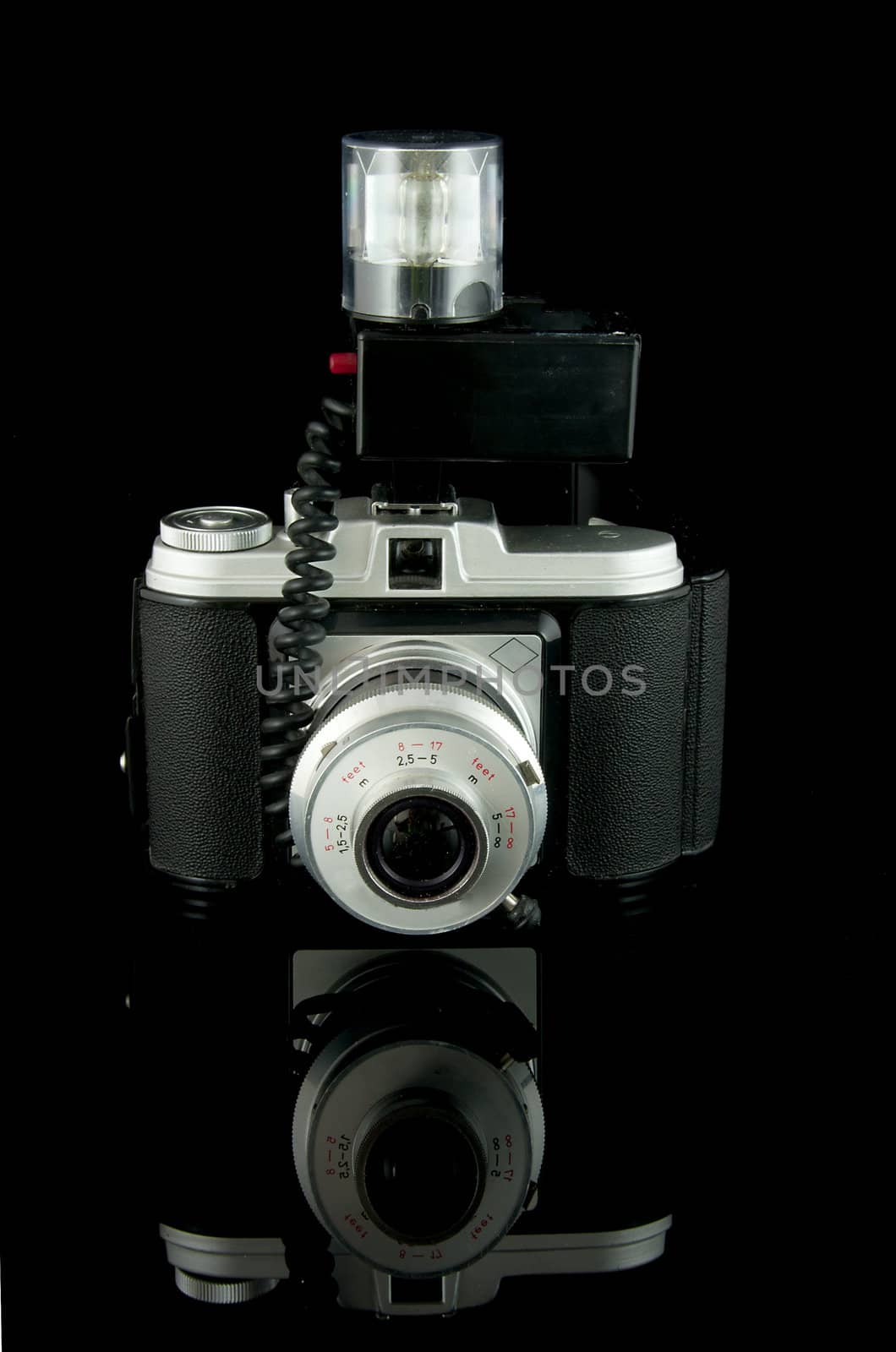 old fashioned photo camera isolated on black background