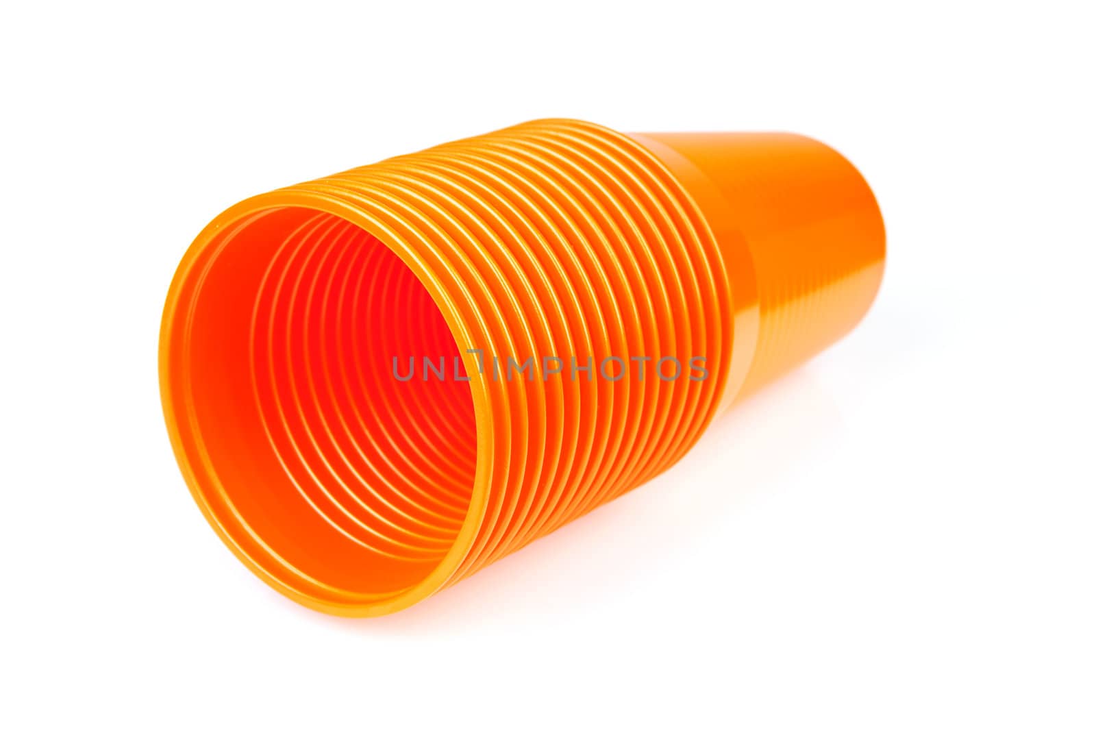 Stack of orange plastic cups isolated on white background