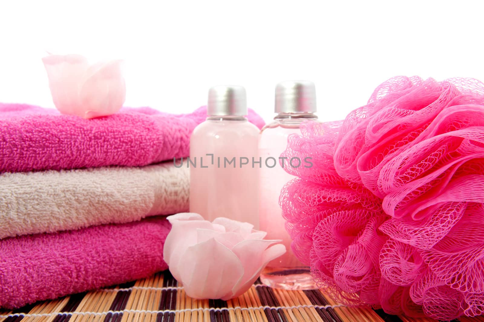pink spa bathroom accessory on cane mat over white background
