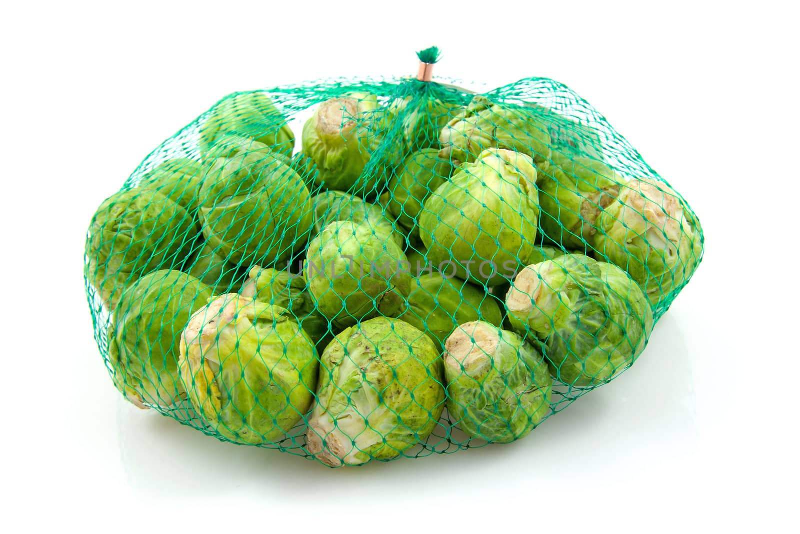Net with Brussels sprouts isolated on white background