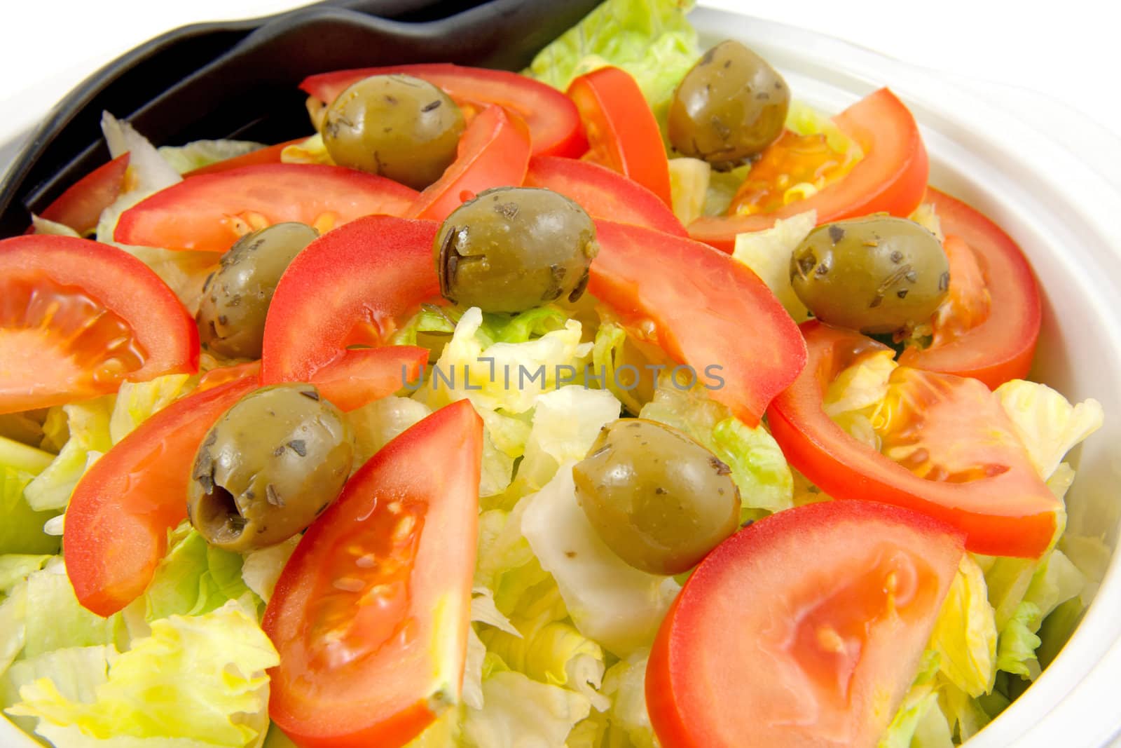 Bowl with fresh salad over white background