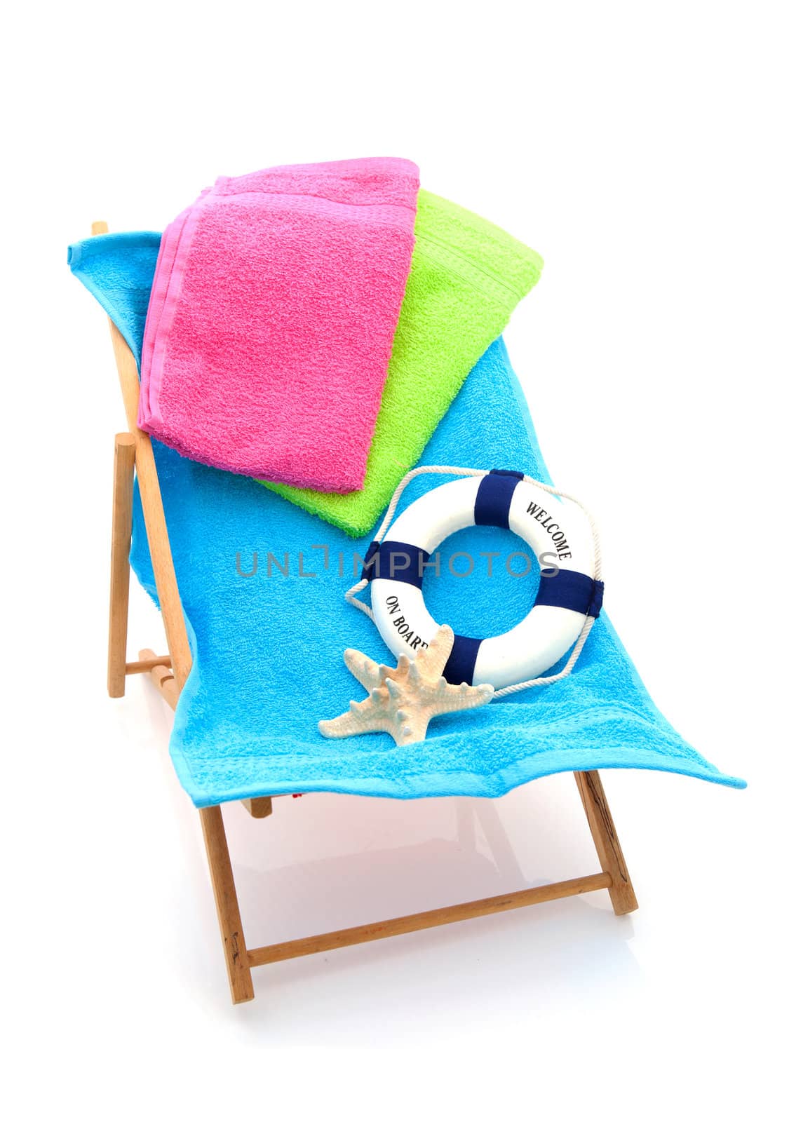 beach chair with colorful towels and life buoy over white background