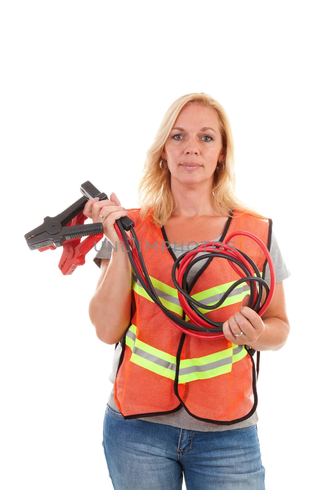 Woman in safety vest holding car jumper cables over white background