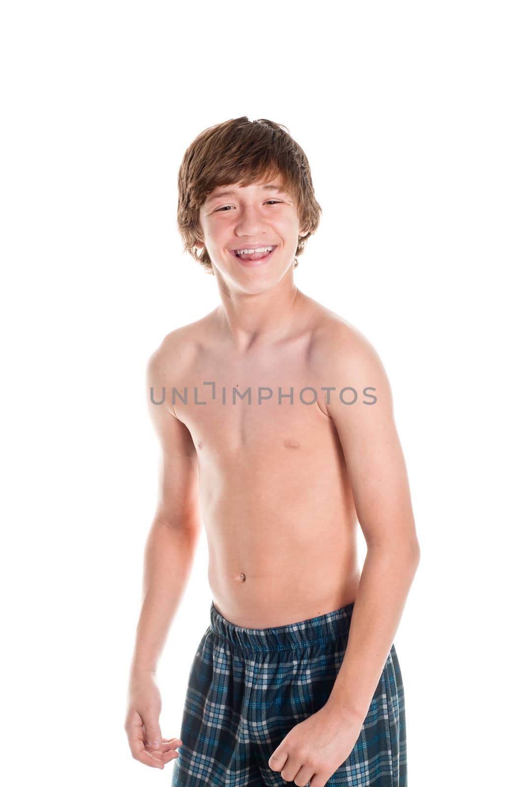 Happy teen in his pajamas. Isolated on white.