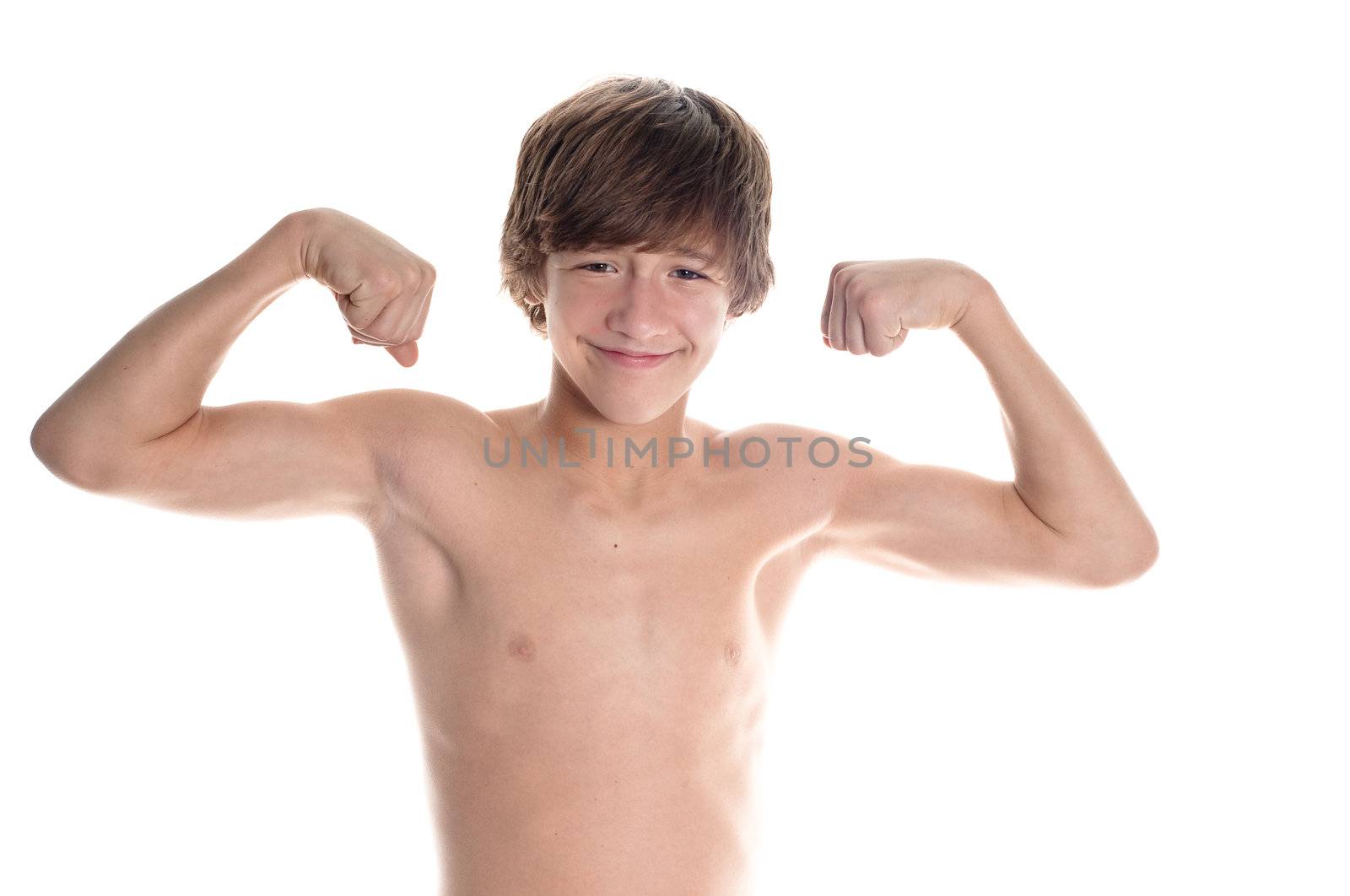 Young teen boy flexing on white background.