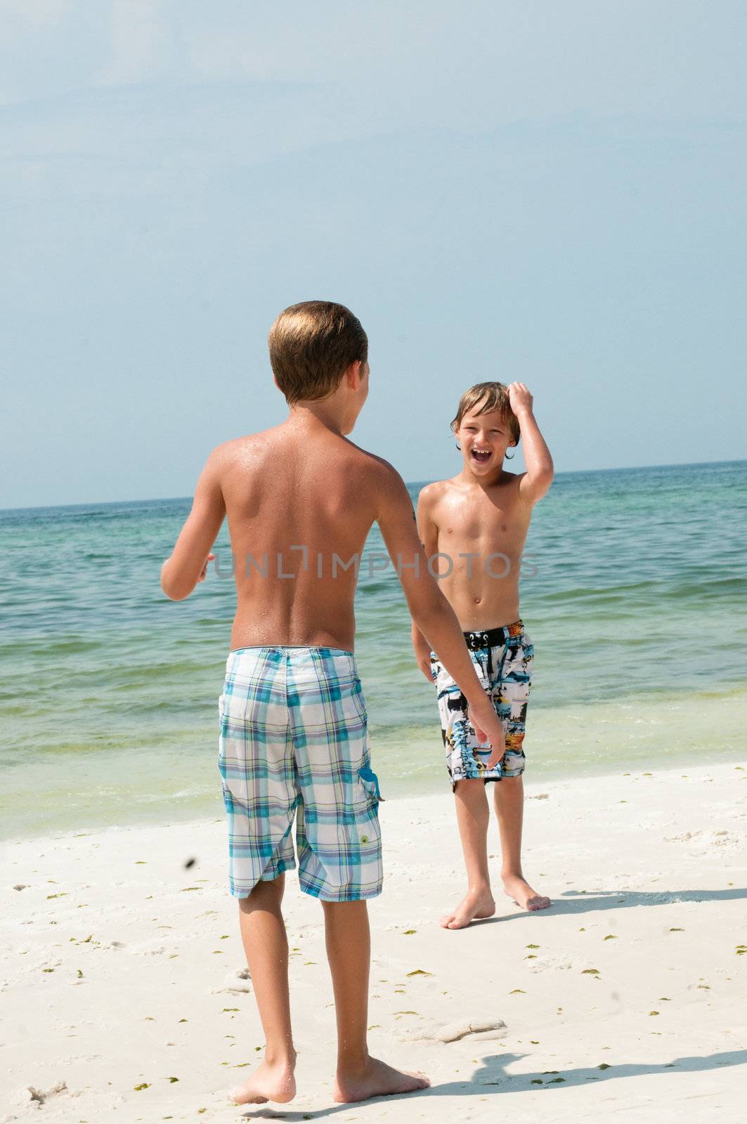 Two boys having fun on the beach.