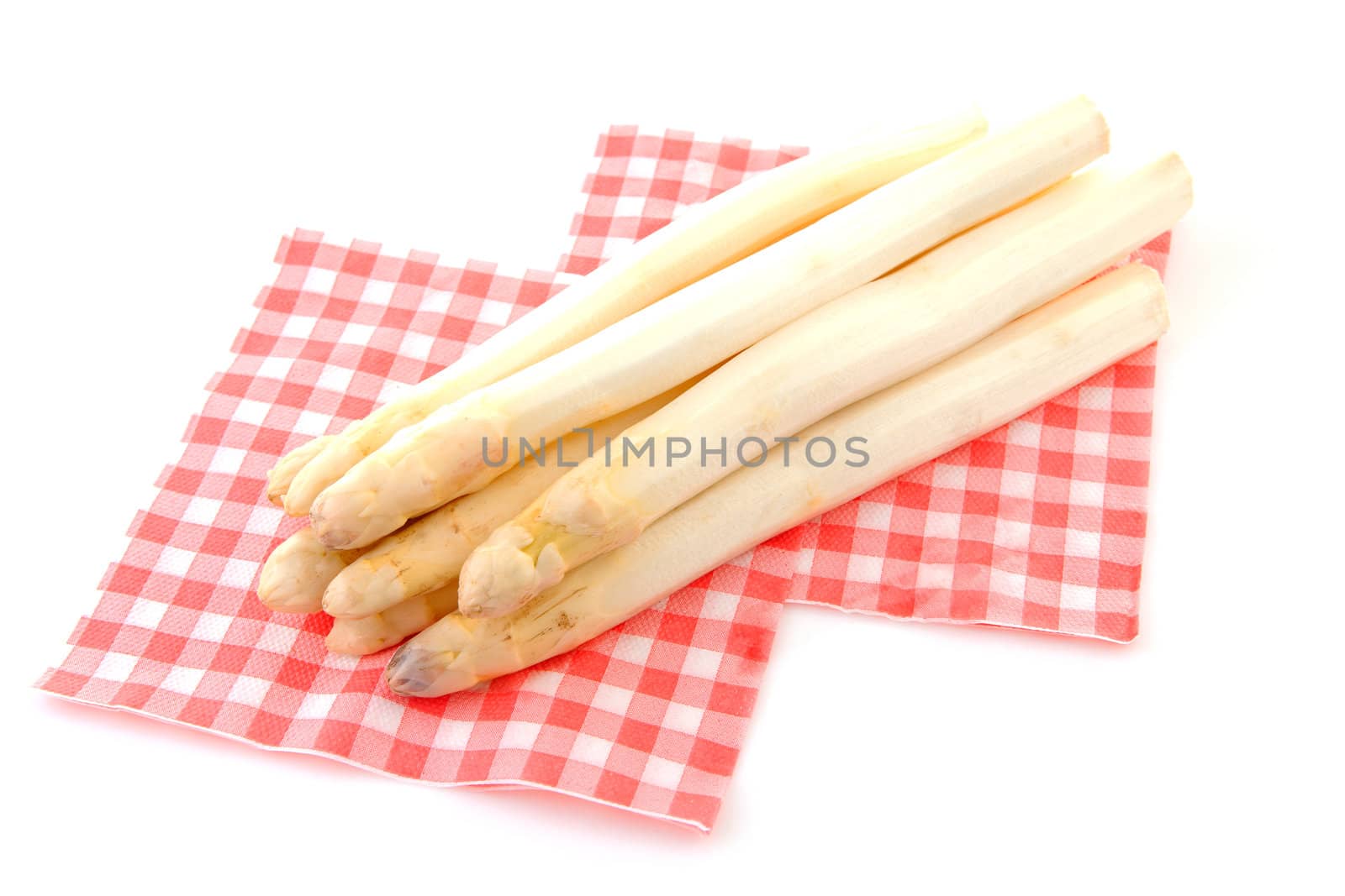 Bundle of fresh Dutch asparagus on napkin over white background